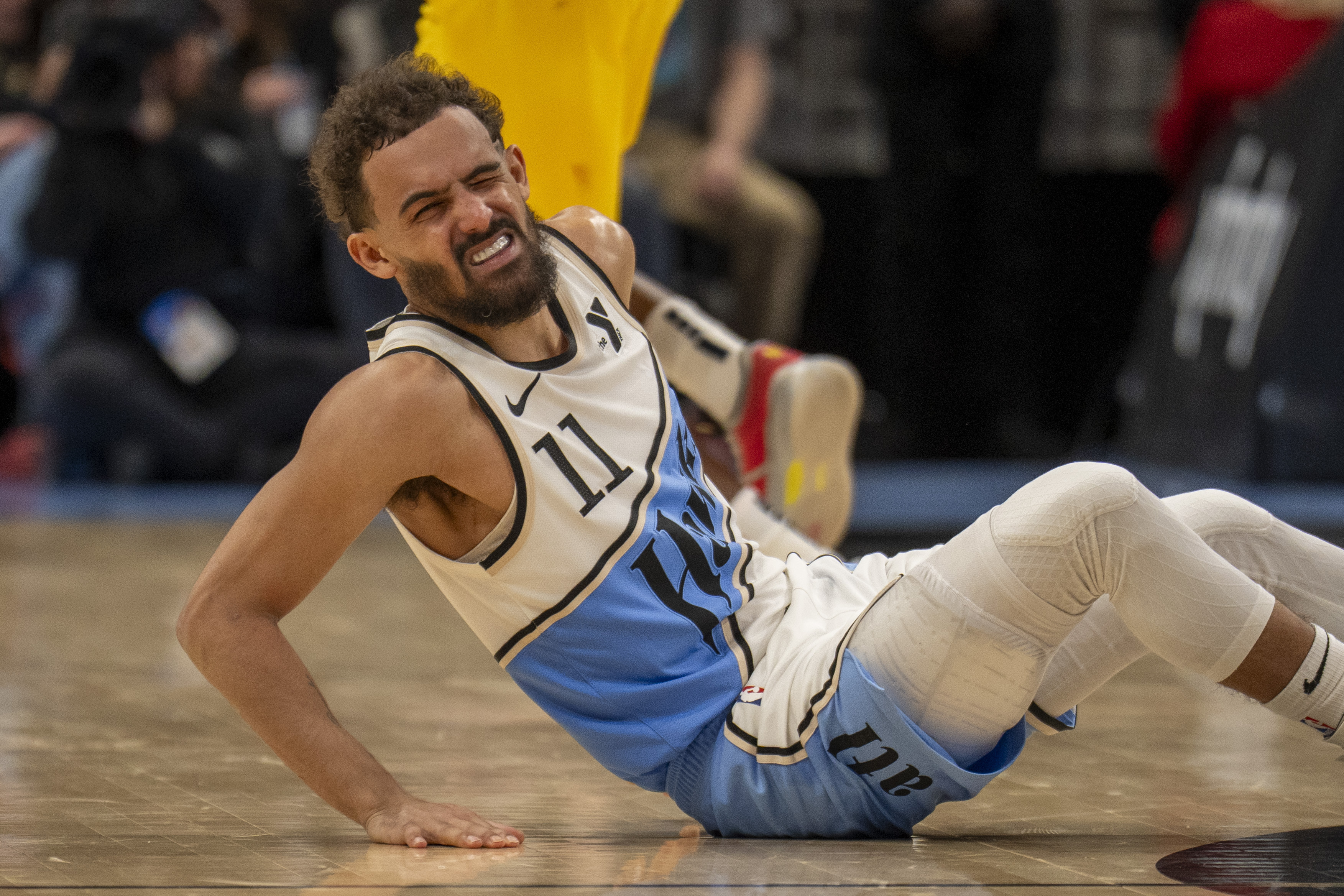Atlanta Hawks guard Trae Young (11) falls from an injury during the second half of an NBA basketball game against the Indiana Pacers, Saturday, March 8, 2025, in Atlanta. 