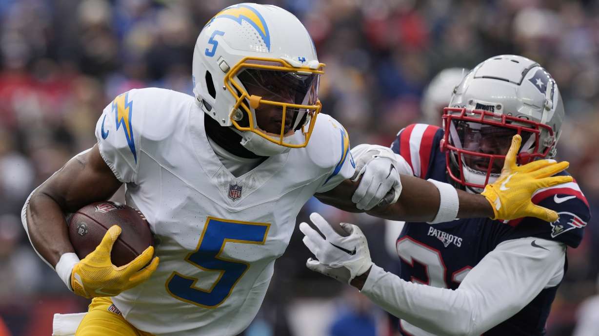 FILE - Los Angeles Chargers wide receiver Joshua Palmer (5) evades New England Patriots cornerback Jonathan Jones (31) during the first half of an NFL football game, Dec. 28, 2024, in Foxborough, Mass.
