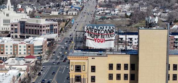 Trump foes breach security of 13-story Ogden building, fly signs critical of the president
