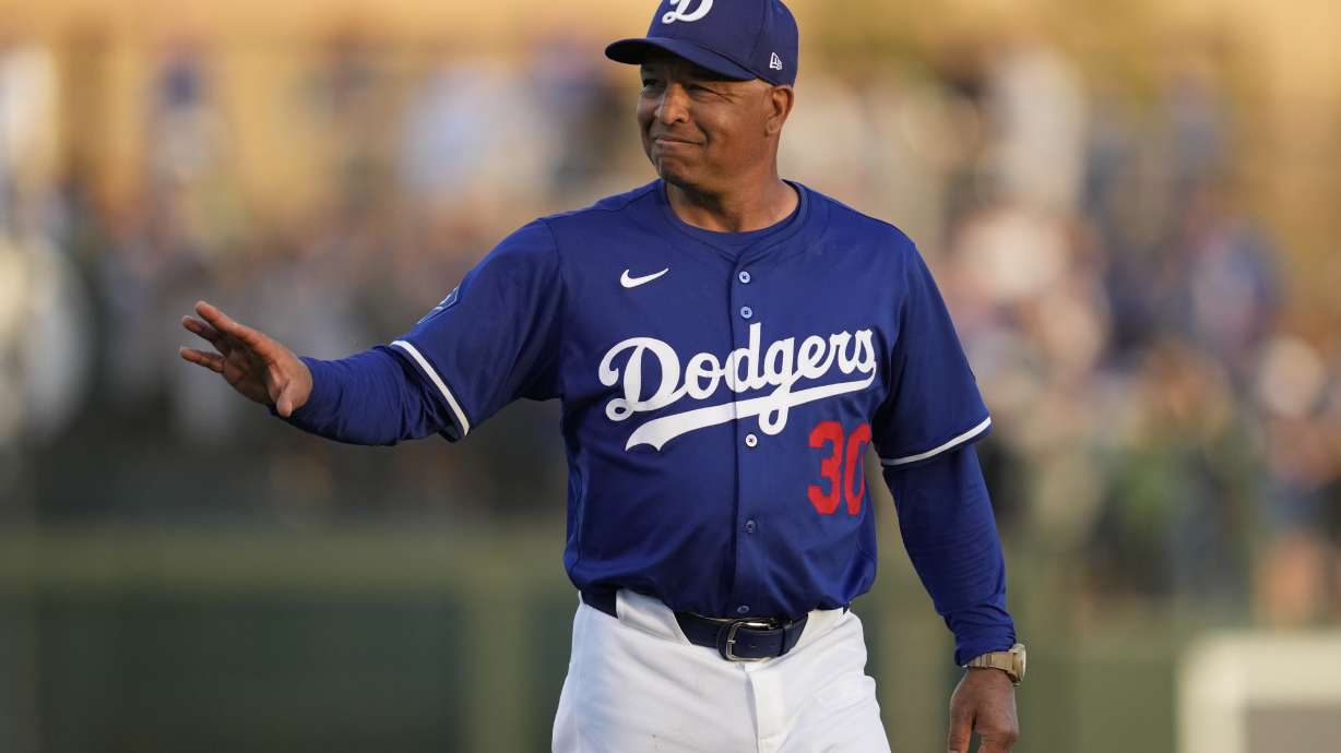 Los Angeles Dodgers manager Dave Roberts walks to the dugout before a spring training baseball game against the Los Angeles Angels, Friday, Feb. 28, 2025, in Phoenix.