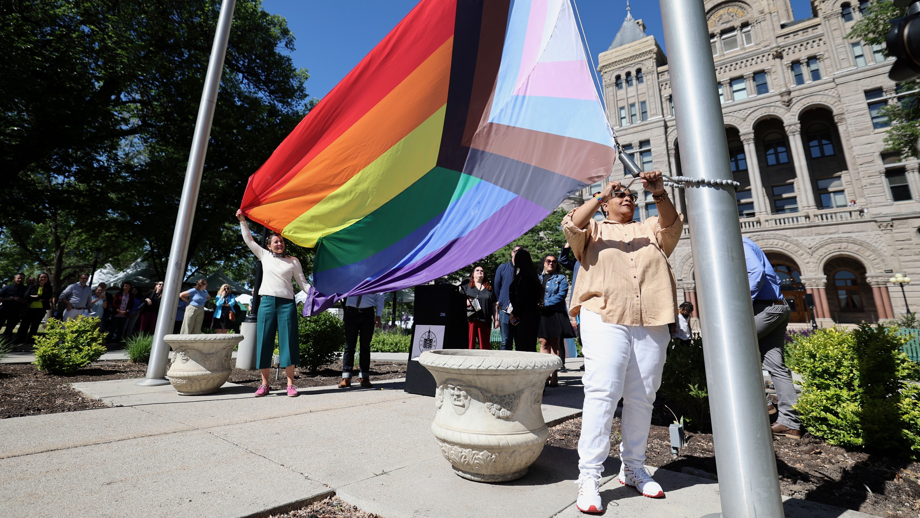 Tanya Hawkins helps raise the Progress Pride flag outside the Salt Lake City-County Building in Salt Lake City on June 1, 2022. HB77, if signed into law, would prohibit the showing of such flags at public buildings and in school classrooms.