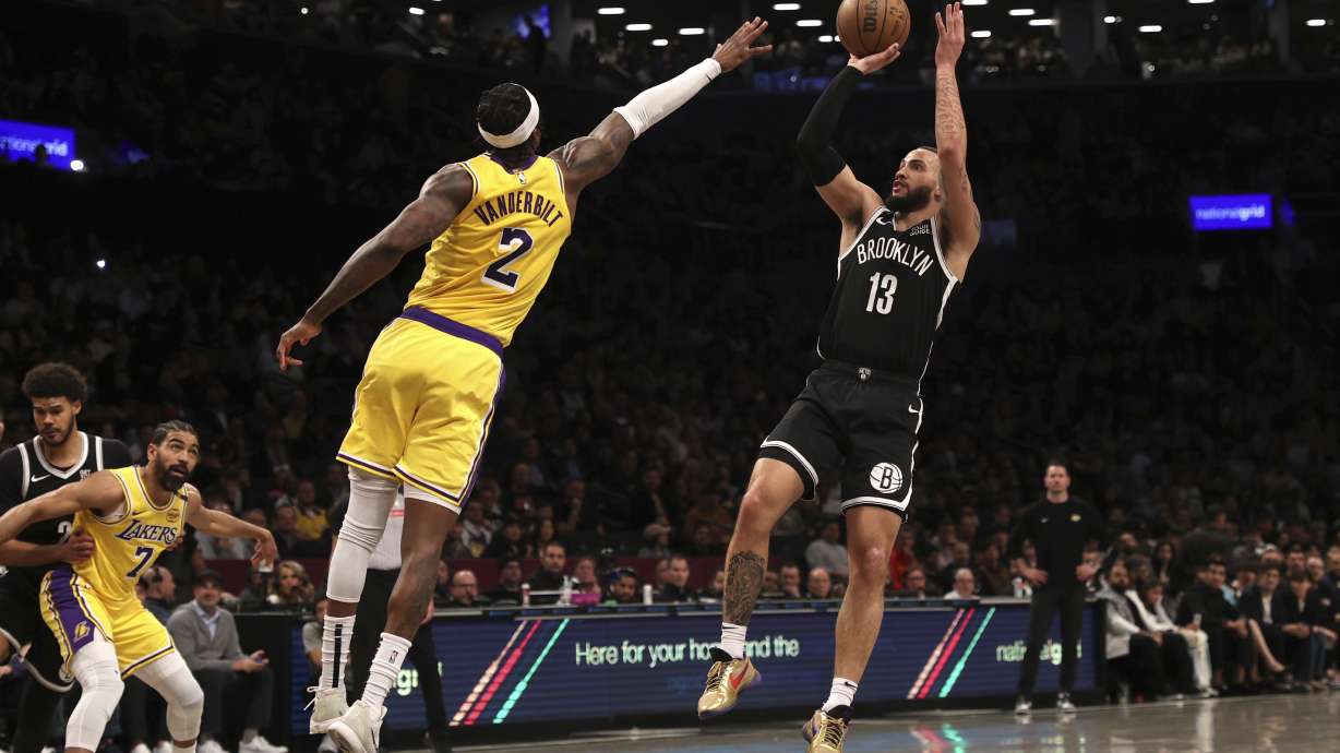 Brooklyn Nets' Tyrese Martin (13) shoots the ball against Los Angeles Lakers' Jarred Vanderbilt (2) during the first half of an NBA basketball game Monday, March 10, 2025, in New York.