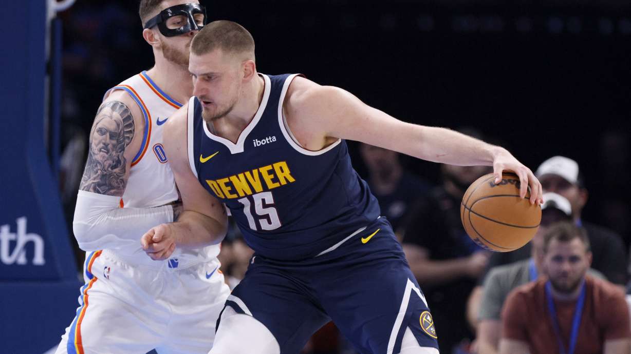 Denver Nuggets center Nikola Jokic (15) goes to the basket against Oklahoma City Thunder center Isaiah Hartenstein during the first half of an NBA basketball game Monday, March 10, 2025, in Oklahoma City.