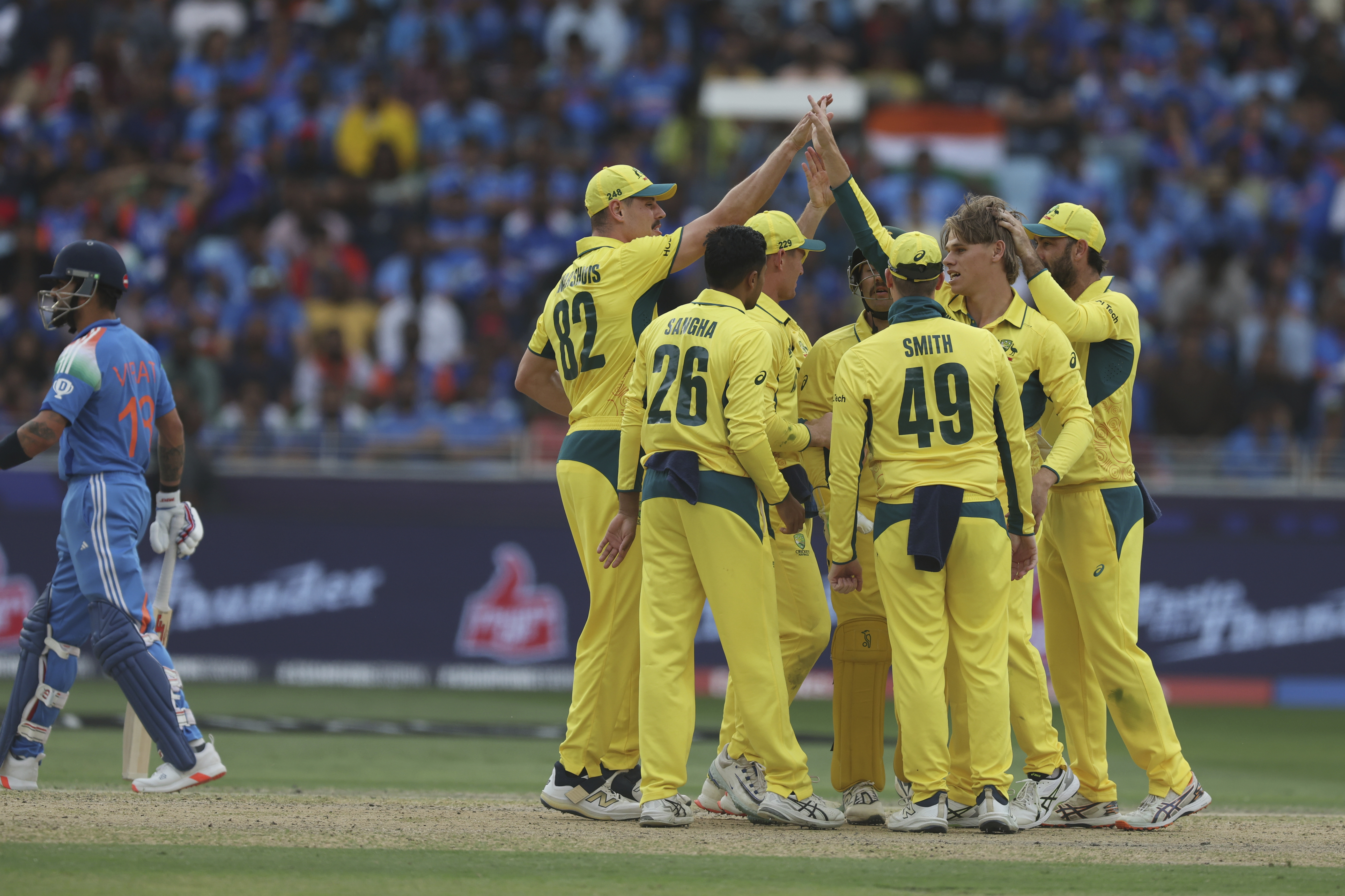 Australia's Cooper Connolly, second right, celebrates the dismissal of India's captain Rohit Sharma, right, during the ICC Champions Trophy semifinal cricket match between India and Australia at Dubai International Cricket Stadium in Dubai, United Arab Emirates, Tuesday, March 4, 2025.