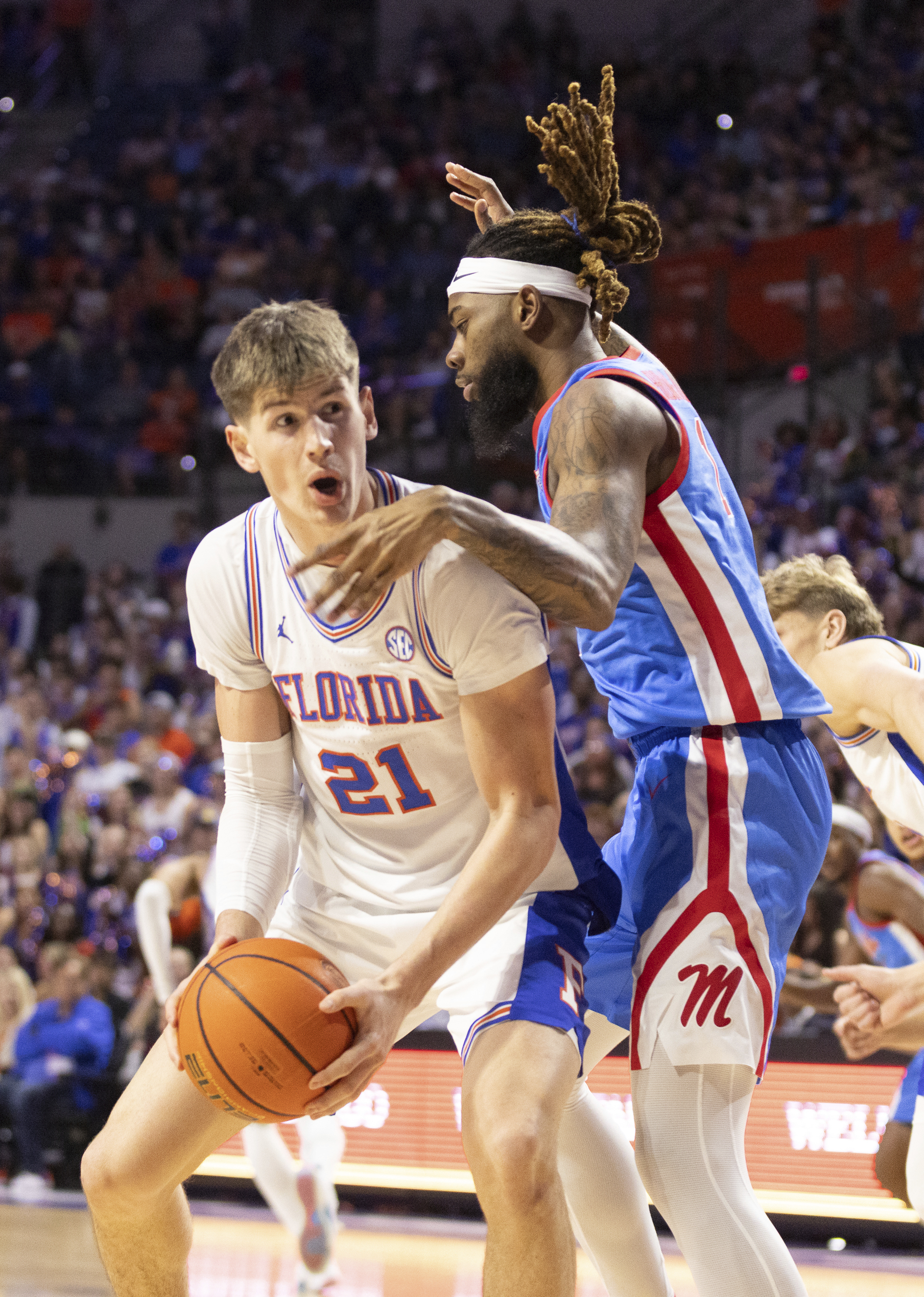 Florida forward Alex Condon (21) takes the rebound from Mississippi forward Mikeal Brown-Jones, right, during the first half of an NCAA college basketball game Saturday, March 8, 2025, in Gainesville, Fla. 