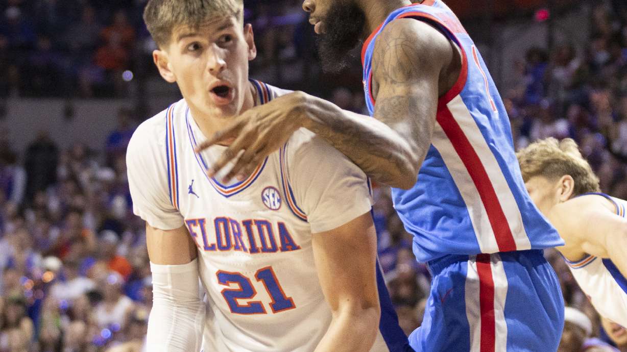 Florida forward Alex Condon (21) takes the rebound from Mississippi forward Mikeal Brown-Jones, right, during the first half of an NCAA college basketball game Saturday, March 8, 2025, in Gainesville, Fla.