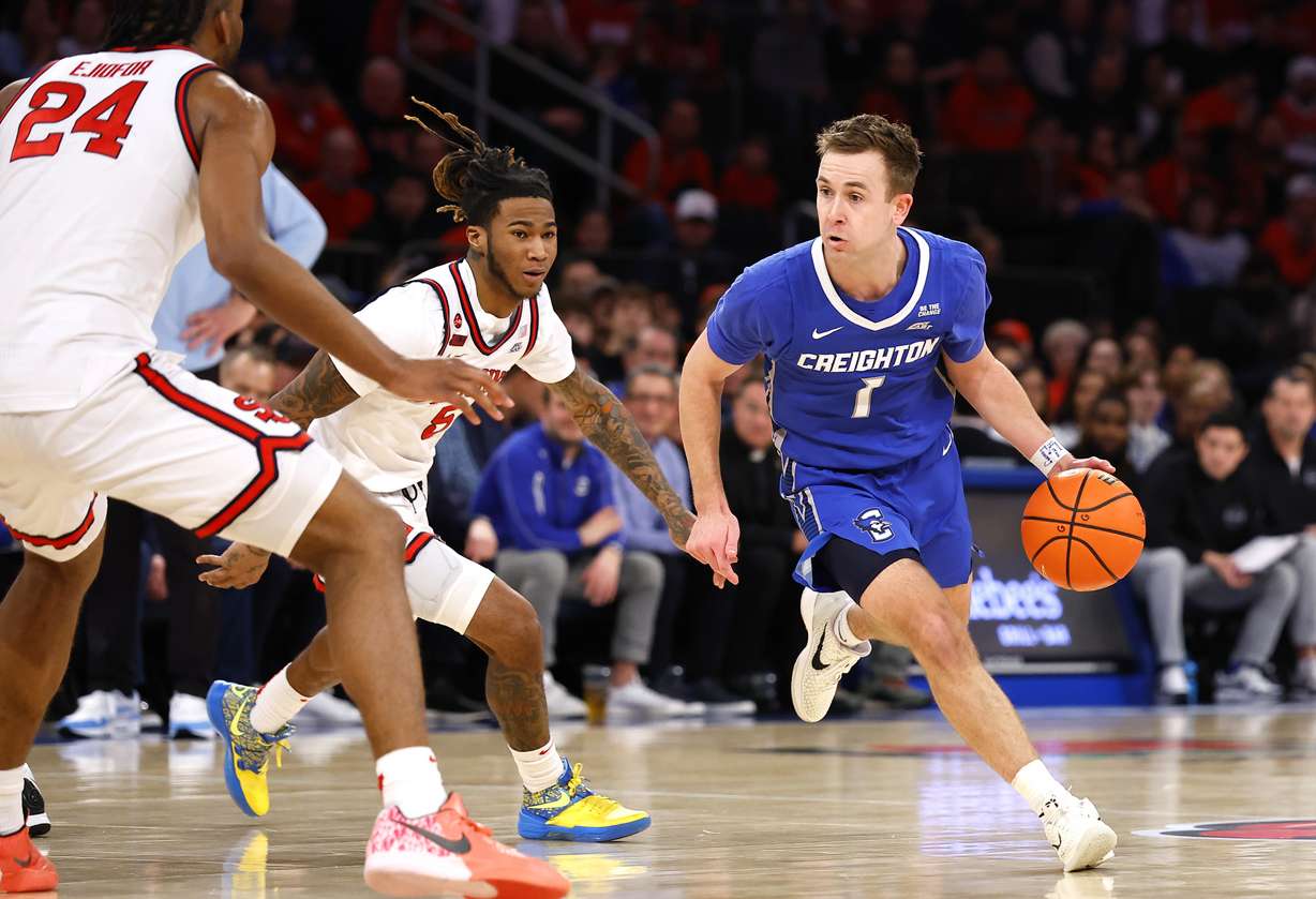 Creighton guard Steven Ashworth (1) drives to the basket against St. John's guard Deivon Smith and forward Zuby Ejiofor (24) during the first half of an NCAA college basketball game, Sunday, Feb. 16, 2025, in New York.