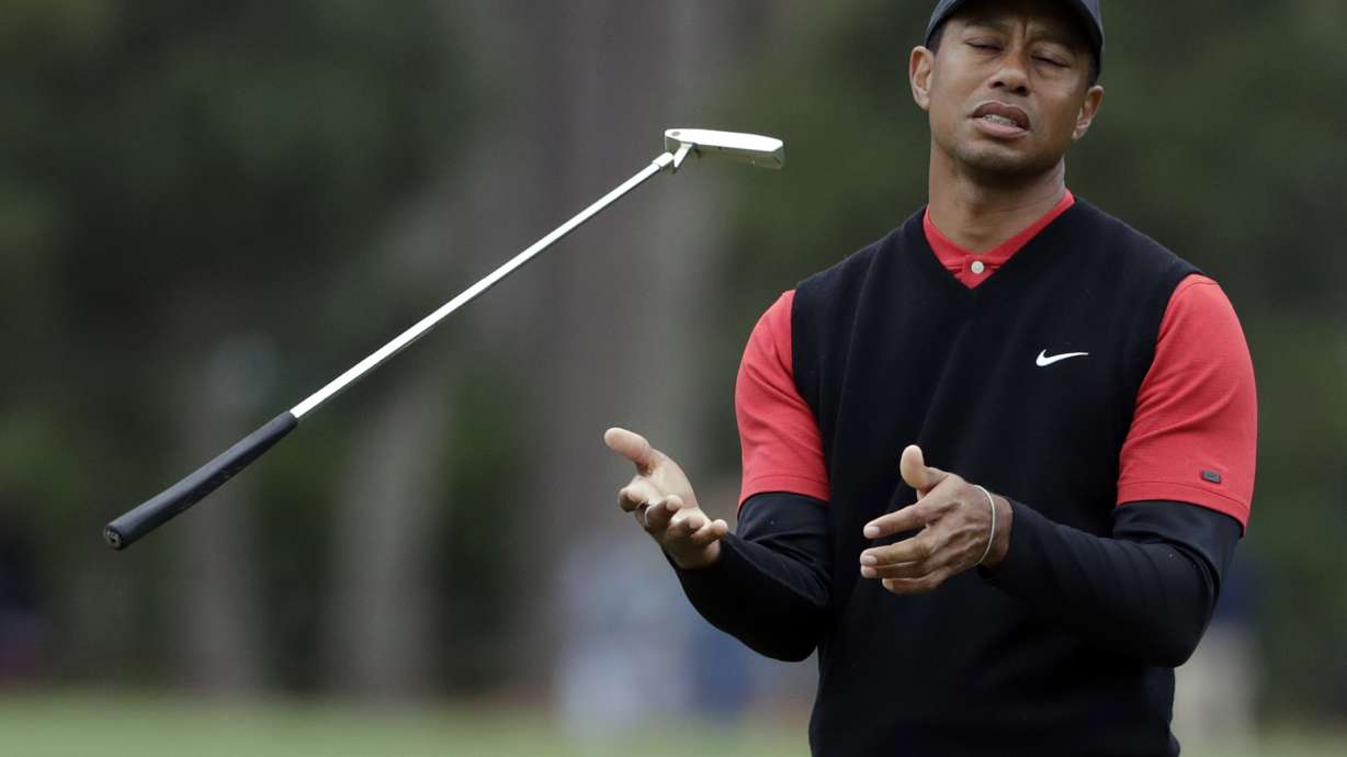 FILE - Tiger Woods flips his club after his shot to the 10th green during the final round of The Players Championship golf tournament Sunday, March 17, 2019, in Ponte Vedra Beach, Fla.