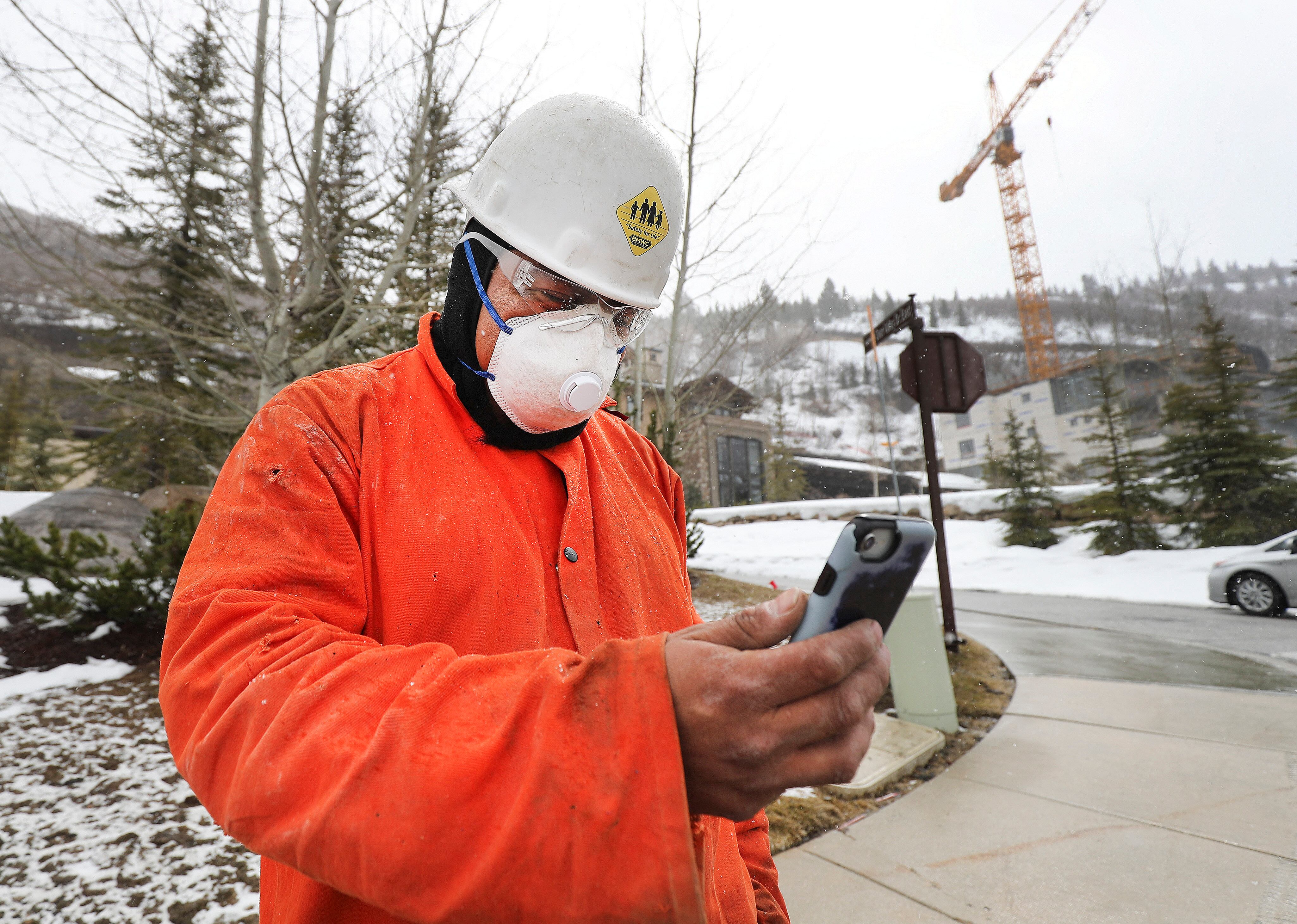 Construction worker Jose Tovar makes a phone call during a break from working on the St. Regis Deer Valley in Park City on March 24, 2020. Tuesday marked five years since the COVID-19 pandemic officially began.