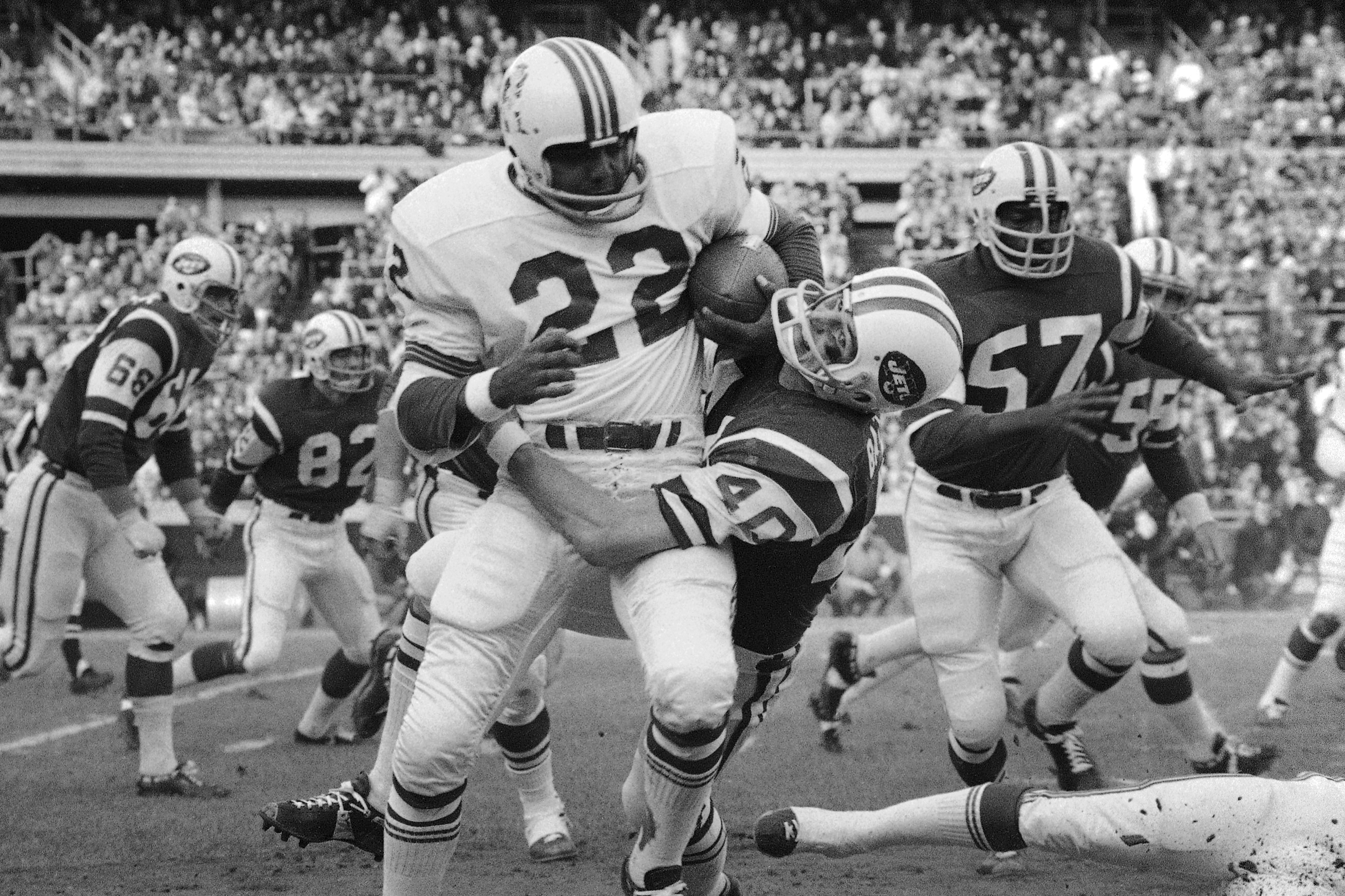 FILE - Boston Patriot Sid Blanks (22) is tackled by New York Jet Mike Battle at Shea Stadium, Sunday Nov. 23, 1970, New York.