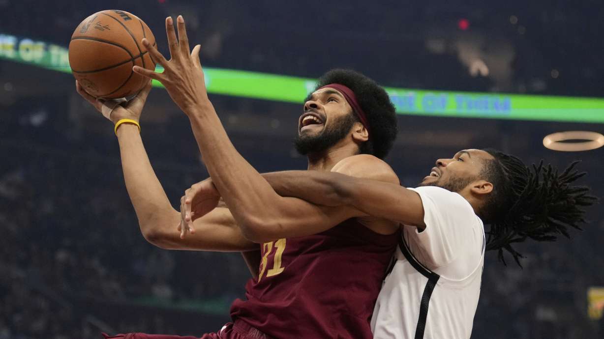 Cleveland Cavaliers center Jarrett Allen (31) is fouled by Brooklyn Nets forward Ziaire Williams, right, in the first half of an NBA basketball game Tuesday, March 11, 2025, in Cleveland.