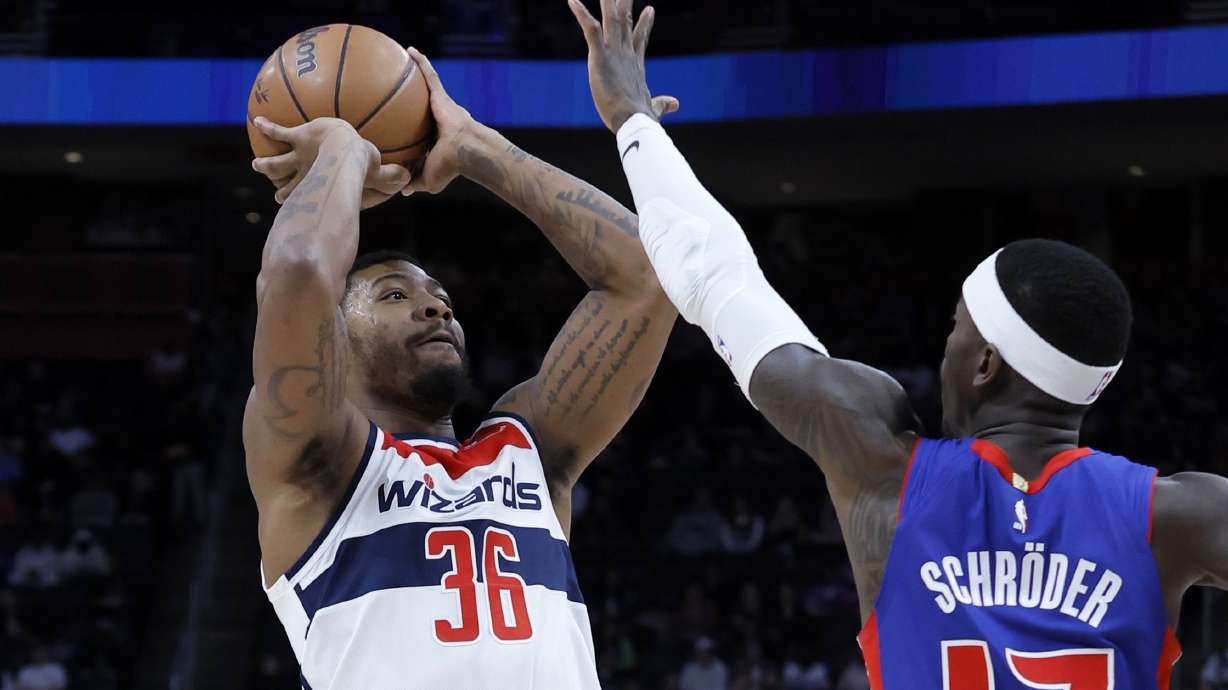 Washington Wizards guard Marcus Smart (36) takes a shot against Detroit Pistons guard Dennis Schroder (17) during the first half of an NBA basketball game Tuesday, March 11, 2025, in Detroit.