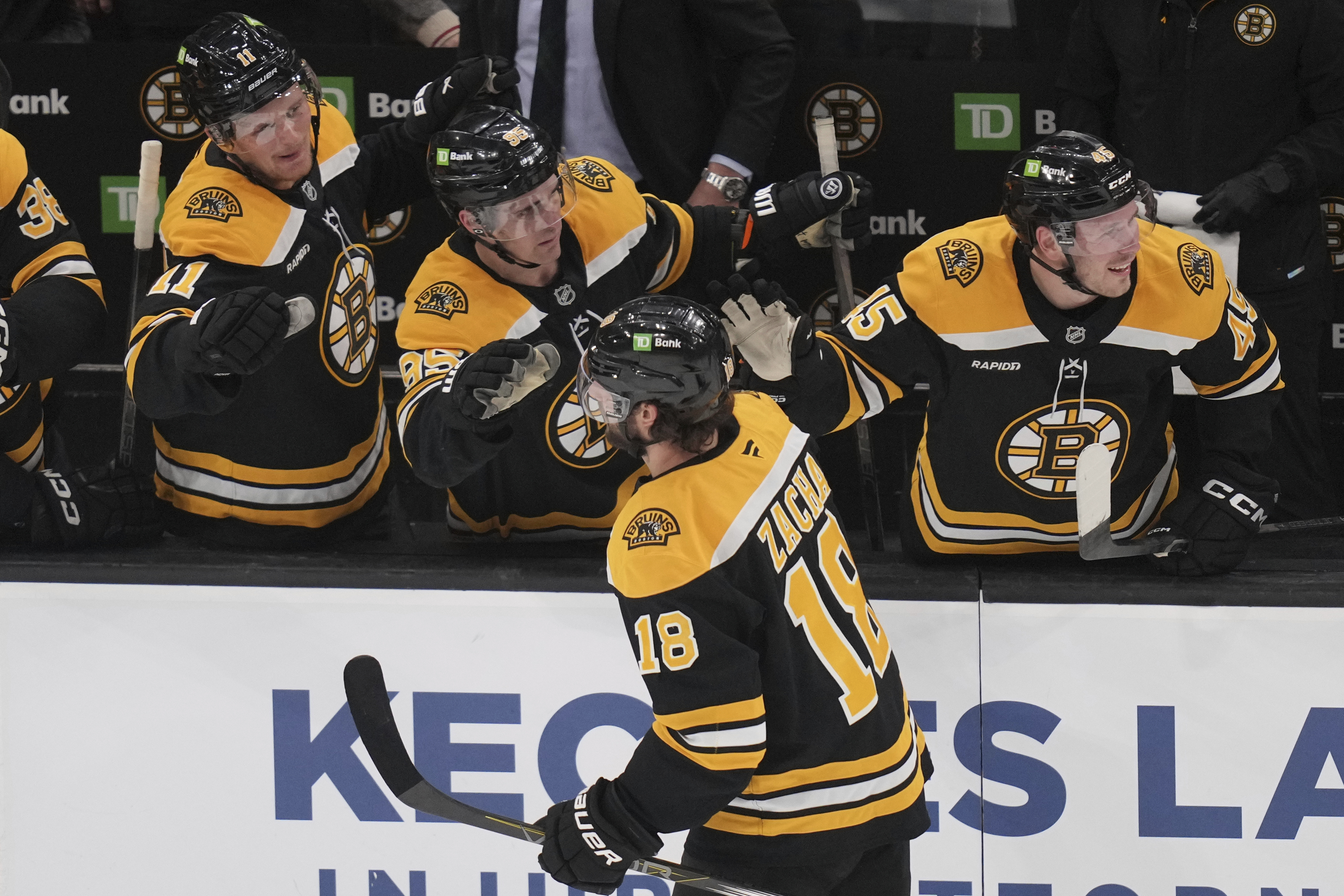 Boston Bruins center Pavel Zacha (18) is congratulated after his goal against the Florida Panthers during the third period of an NHL hockey game, Tuesday, March 11, 2025, in Boston.