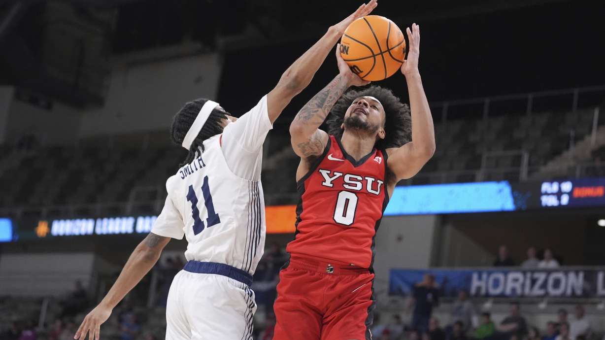 Youngstown State guard Jason Nelson (0) shoots over Robert Morris guard DJ Smith (11) in the second half of an NCAA college basketball game in the championship of the Horizon League tournament in Indianapolis, Tuesday, March 11, 2025.