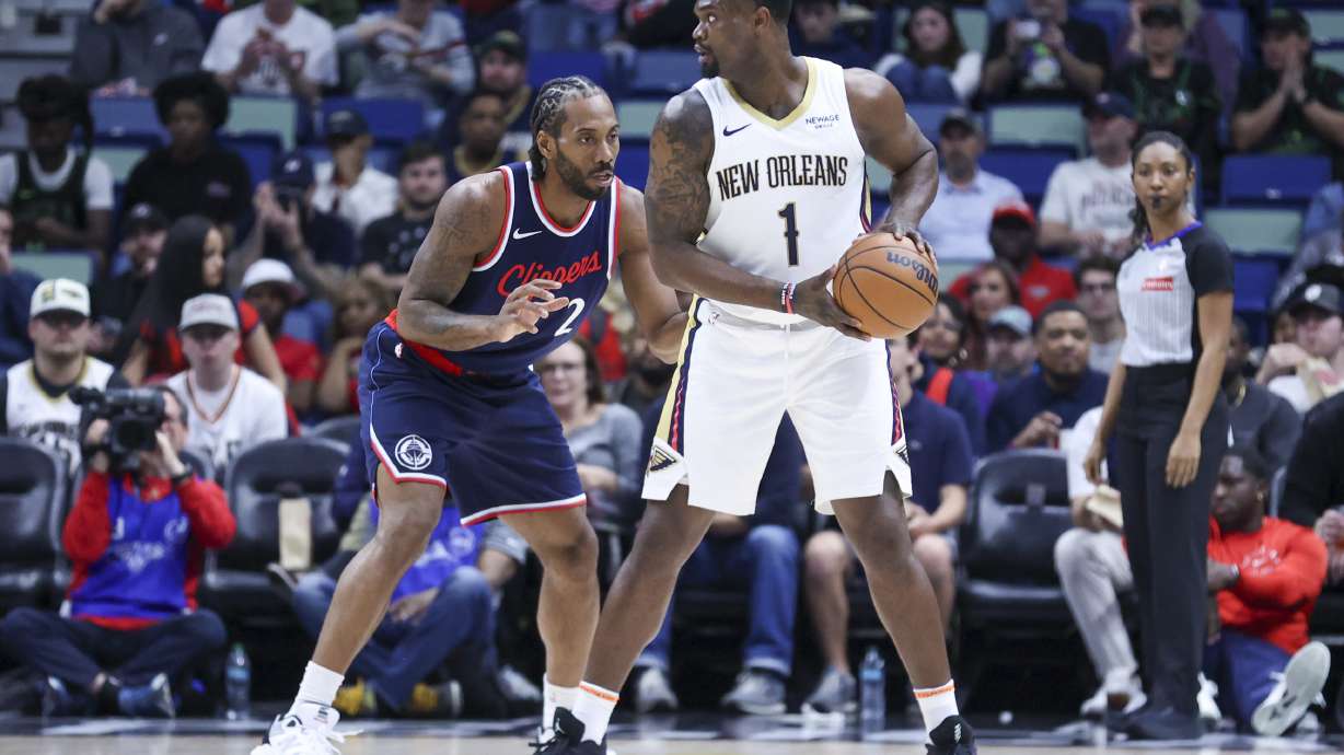 New Orleans Pelicans forward Zion Williamson (1) tries to make a move against Los Angeles Clippers forward Kawhi Leonard (2) in the first half of an NBA basketball game in New Orleans, Tuesday, March 11, 2025.
