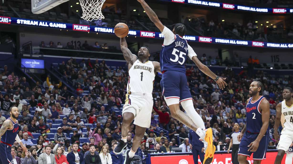 New Orleans Pelicans forward Zion Williamson (1) throws down a dunk on Los Angeles Clippers forward Derrick Jones Jr. (55) in the second half of an NBA basketball game in New Orleans, Tuesday, March 11, 2025.