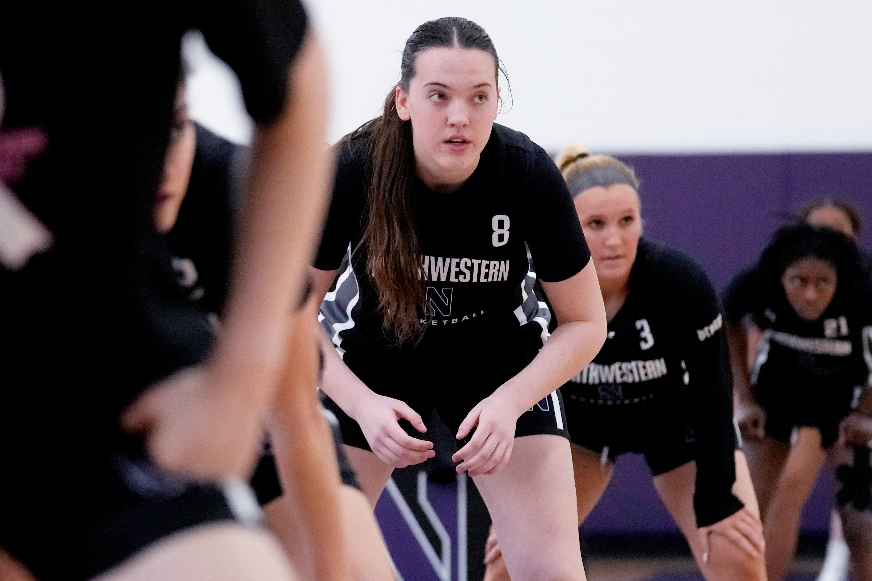 Northwestern freshman Kat Righeimer, one of six women from Kobe Bryant’s Mamba Academy going through their first experience with college basketball, warms up with teammates during NCAA college basketball practice in Evanston, Ill., Tuesday, Feb. 25, 2025.