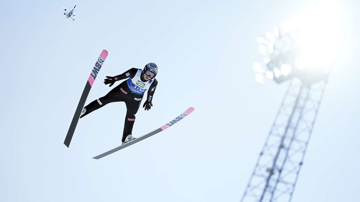=Marius Lindvik, of Norway, soars through the air during his first round jump of the ski jumping men's team large hill competition at the Nordic World Ski Championships in Trondheim, Norway, Thursday, March 6, 2025.