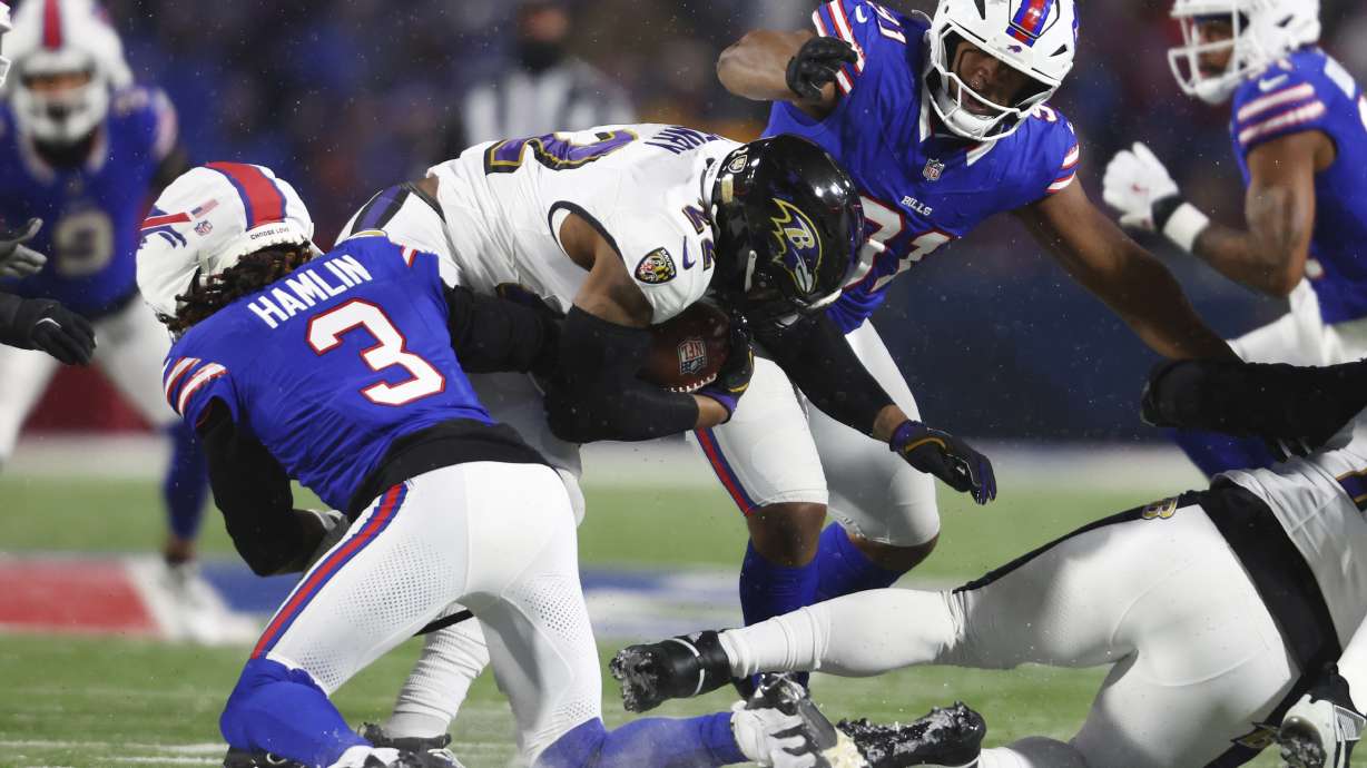 FILE - Baltimore Ravens running back Derrick Henry (22) is brought down by Buffalo Bills safety Damar Hamlin (3) during the first half of an NFL football divisional playoff game in Orchard Park, N.Y., Jan. 19, 2025.