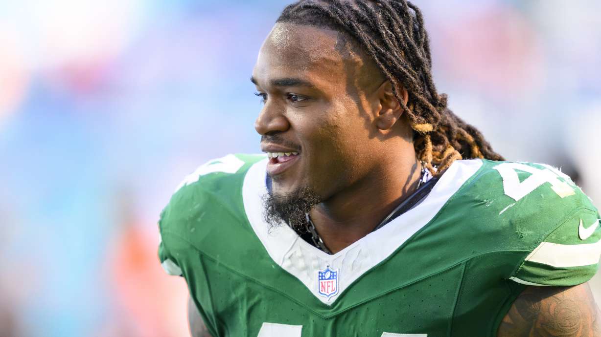 FILE - New York Jets linebacker Jamien Sherwood (44) smiles as he walks back to the locker room during an NFL football game against the Miami Dolphins, Dec. 8, 2024, in Miami Gardens, Fla.