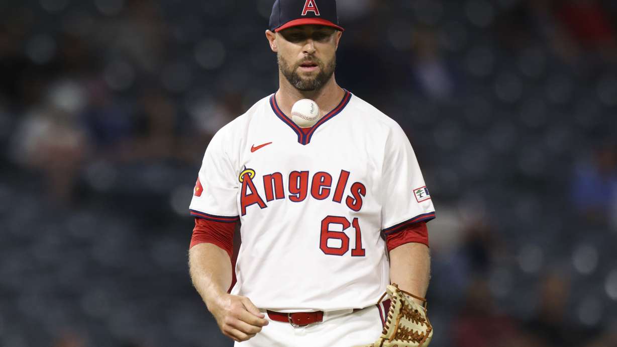 FILE - Los Angeles Angels pitcher Hunter Strickland (61) tosses the ball during the ninth inning of a baseball game against the Colorado Rockies in Anaheim, Calif., Tuesday, July 30, 2024.