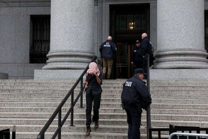 A woman leaves Thurgood Marshall United States Courthouse, after a hearing on the detention of Palestinian activist and Columbia University graduate student Mahmoud Khalil, in New York City, Wednesday.