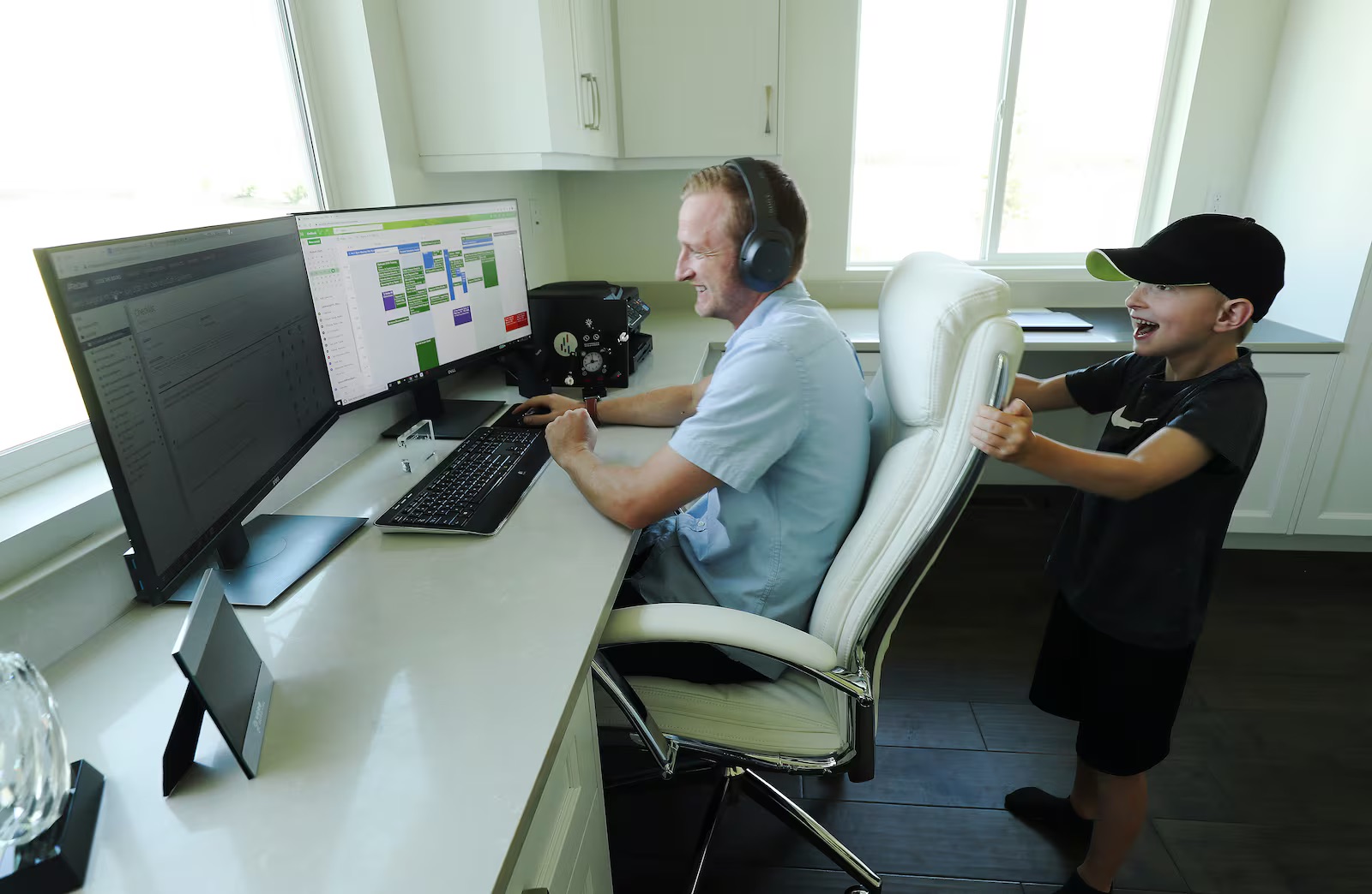 Tyson Oldham works in his home office as his son Carson, 7, rattles his chair in Highland on Aug. 14, 2020.