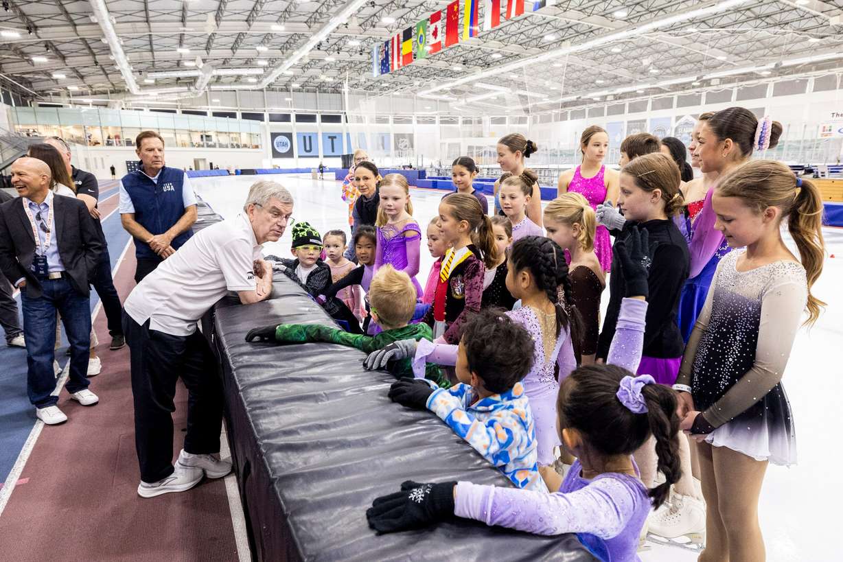 International Olympic Committee President Thomas Bach talks with youth figure skaters at the Utah Olympic Oval in Kearns on Sept. 28. 2024.