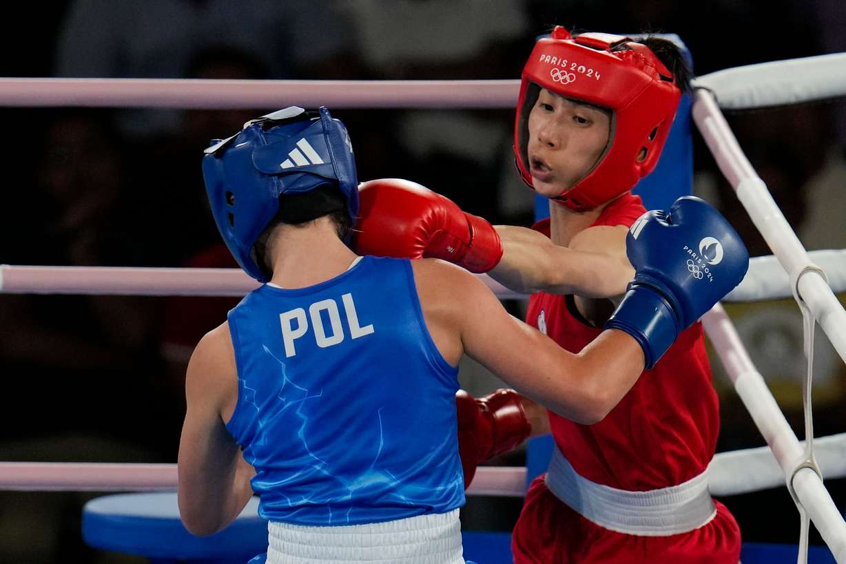Taiwan's Lin Yu-ting, right, fights Poland's Julia Szeremeta in their women's 57 kg final boxing match at the 2024 Summer Olympics, Aug. 10, 2024, in Paris, France.