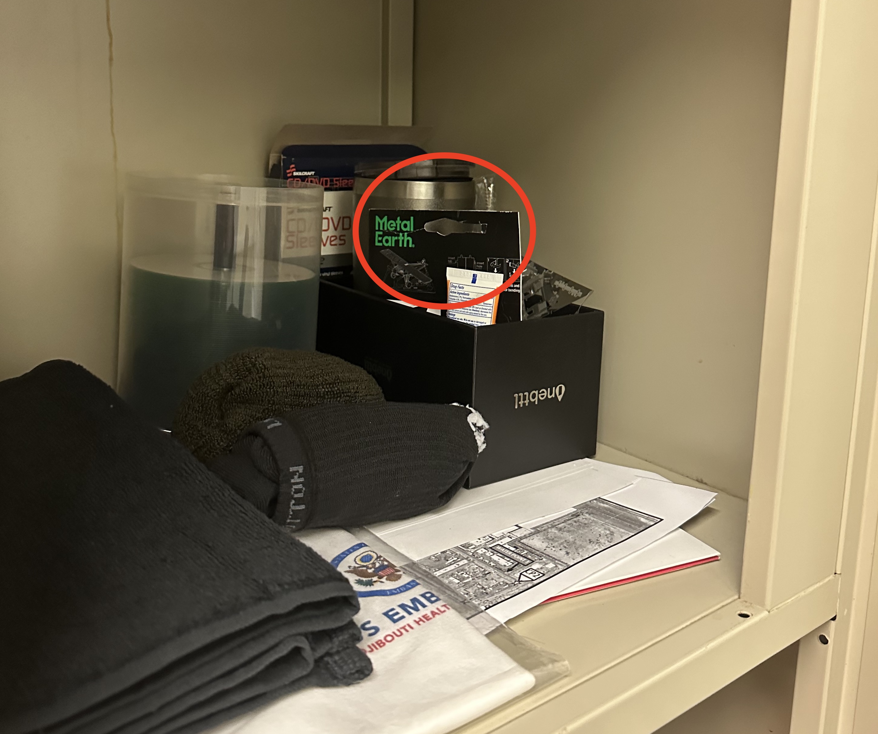 A photograph of the corner of a cubby in Army Maj. Kenton L. Francis's office, taken right after a woman found a phone hidden behind paper packaging to record her changing.