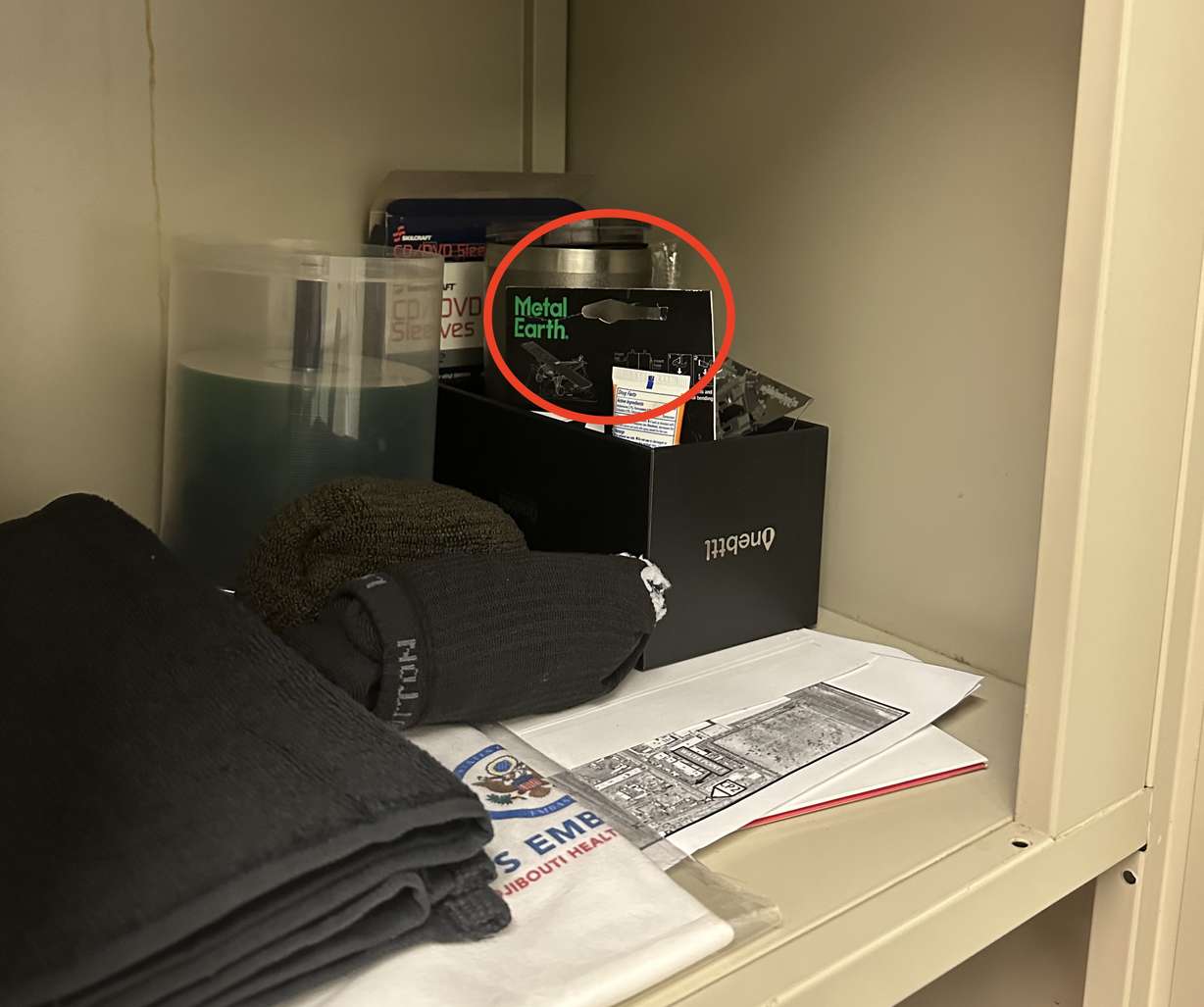 A photograph of the corner of a cubby in Army Maj. Kenton L. Francis's office, taken right after a woman found a phone hidden behind paper packaging to record her changing.