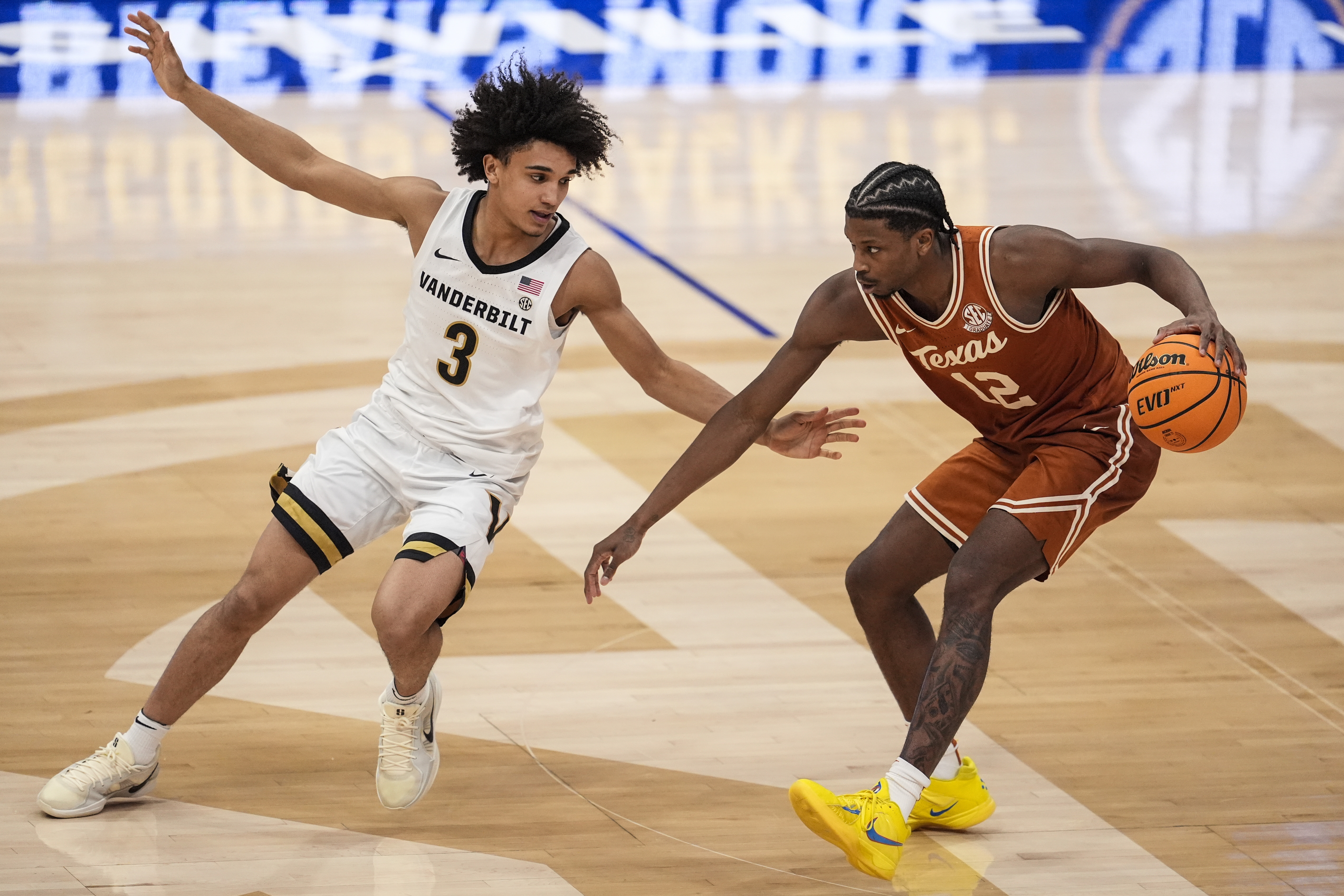 Texas guard Tramon Mark (12) drives against Vanderbilt guard Tyler Tanner (3) during the second half of an NCAA college basketball game at the Southeastern Conference tournament, Wednesday, March 12, 2025, in Nashville, Tenn. 