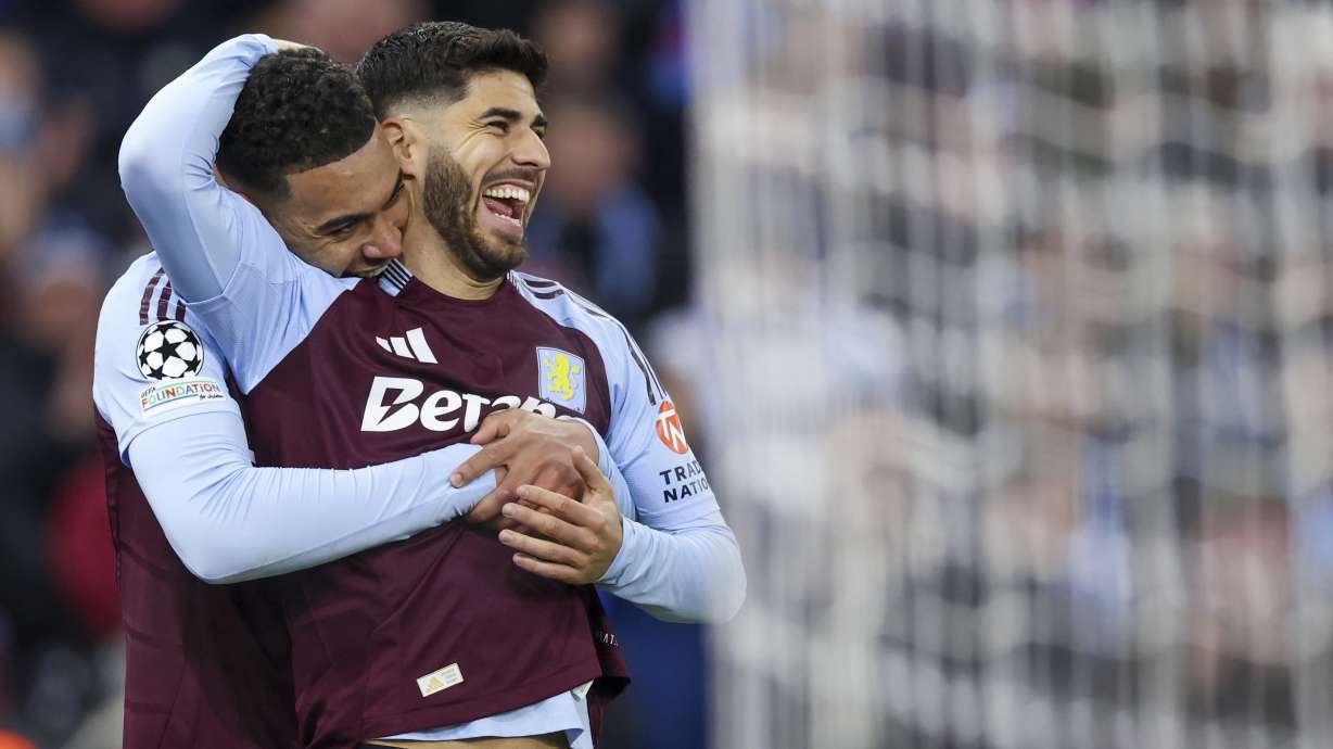 Aston Villa's Marco Asensio, right, celebrates with Aston Villa's Morgan Rogers after scoring his side's third goal during the Champions League round of 16 second leg soccer match between Aston Villa and Club Brugge at the Villa Park stadium in Birmingham, England, Wednesday, March 12, 2025.