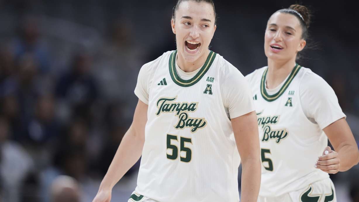 South Florida's Carla Brito (55) and Vittoria Blasigh (5) celebrate a three-pointer made by Brito in the first half of an NCAA college basketball game against Rice during the women's final of the American Athletic Conference tournament in Fort Worth, Texas, Wednesday, March 12, 2025.