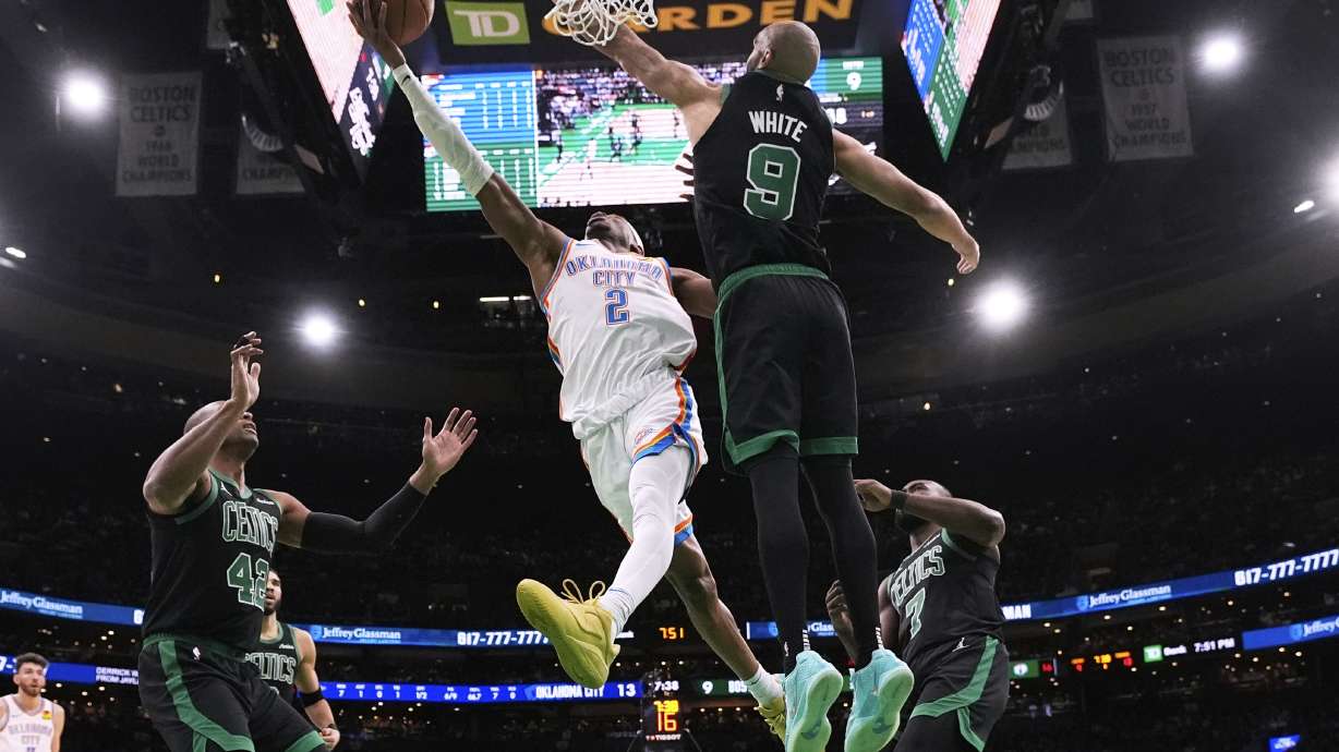 Oklahoma City Thunder guard Shai Gilgeous-Alexander (2) drive to the basket against Boston Celtics guard Derrick White (9) during the first half of an NBA basketball game, Wednesday, March 12, 2025, in Boston.