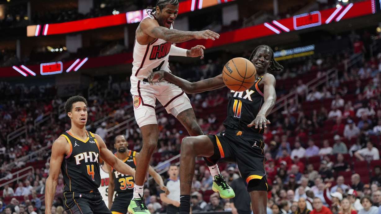 Houston Rockets' Jalen Green (4) loses the ball as Phoenix Suns' Bol Bol (11) defends during the first half of an NBA basketball game Wednesday, March 12, 2025, in Houston.