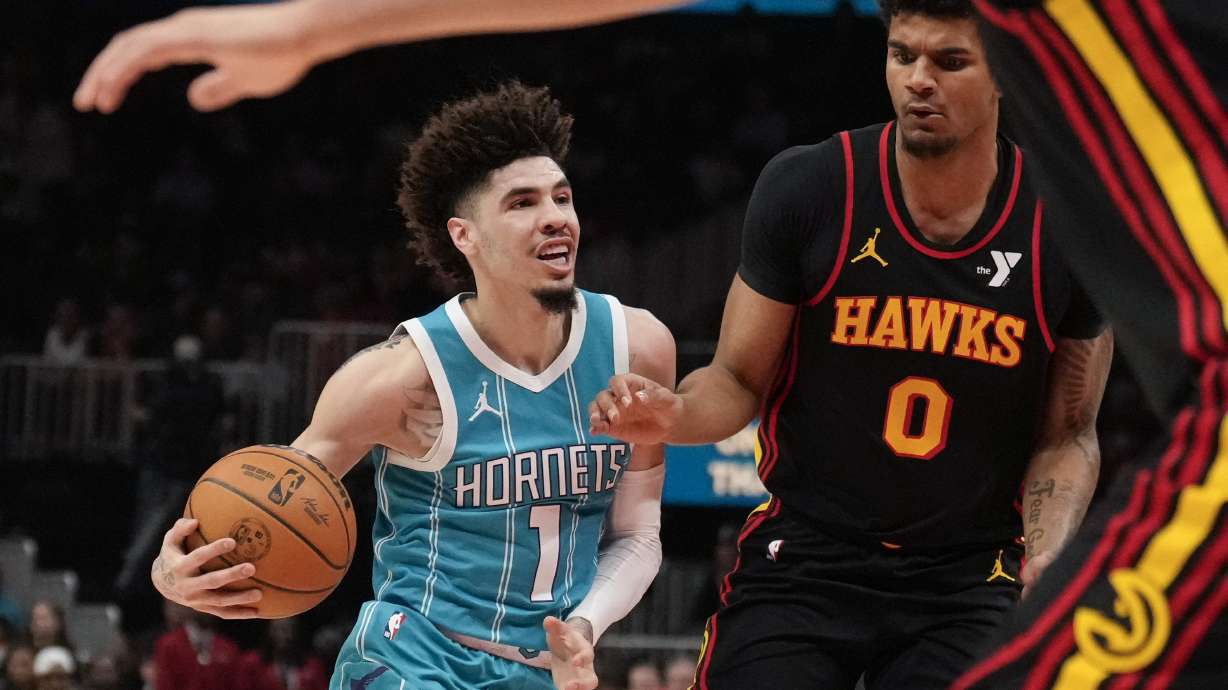 Charlotte Hornets guard LaMelo Ball (1) dribbles against Atlanta Hawks forward Dominick Barlow (0) in the first half of an NBA basketball game, Wednesday, March 12, 2025, in Atlanta.