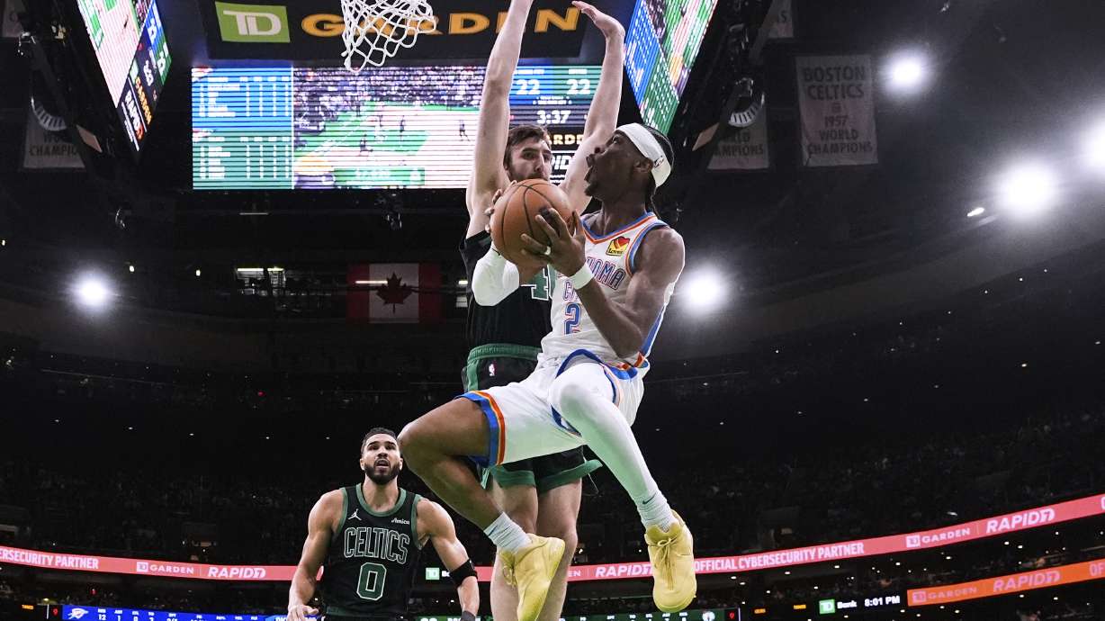 Oklahoma City Thunder guard Shai Gilgeous-Alexander (2) drive to the basket against Boston Celtics center Luke Kornet, rear right, and forward Jayson Tatum (0) during the first half of an NBA basketball game, Wednesday, March 12, 2025, in Boston.