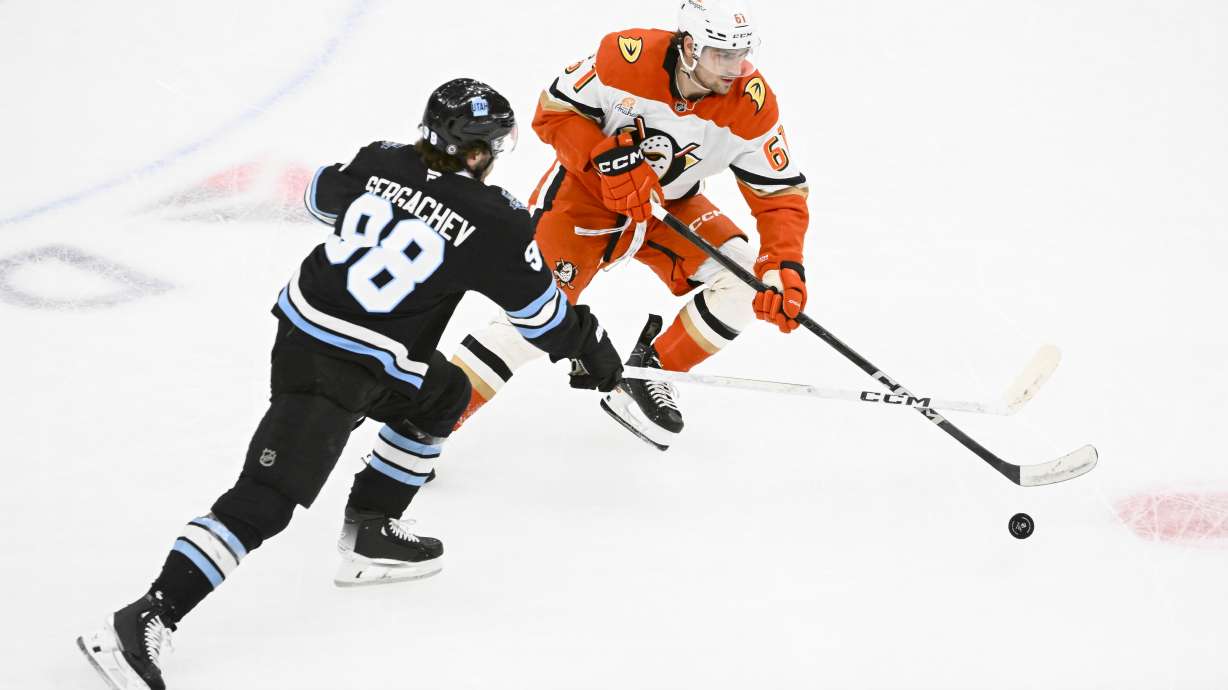 Utah Hockey Club defenseman Mikhail Sergachev (98) and Anaheim Ducks left wing Cutter Gauthier (61) battle for the puck during the first period of an NHL hockey game, Wednesday, March 12, 2025, in Salt Lake City.