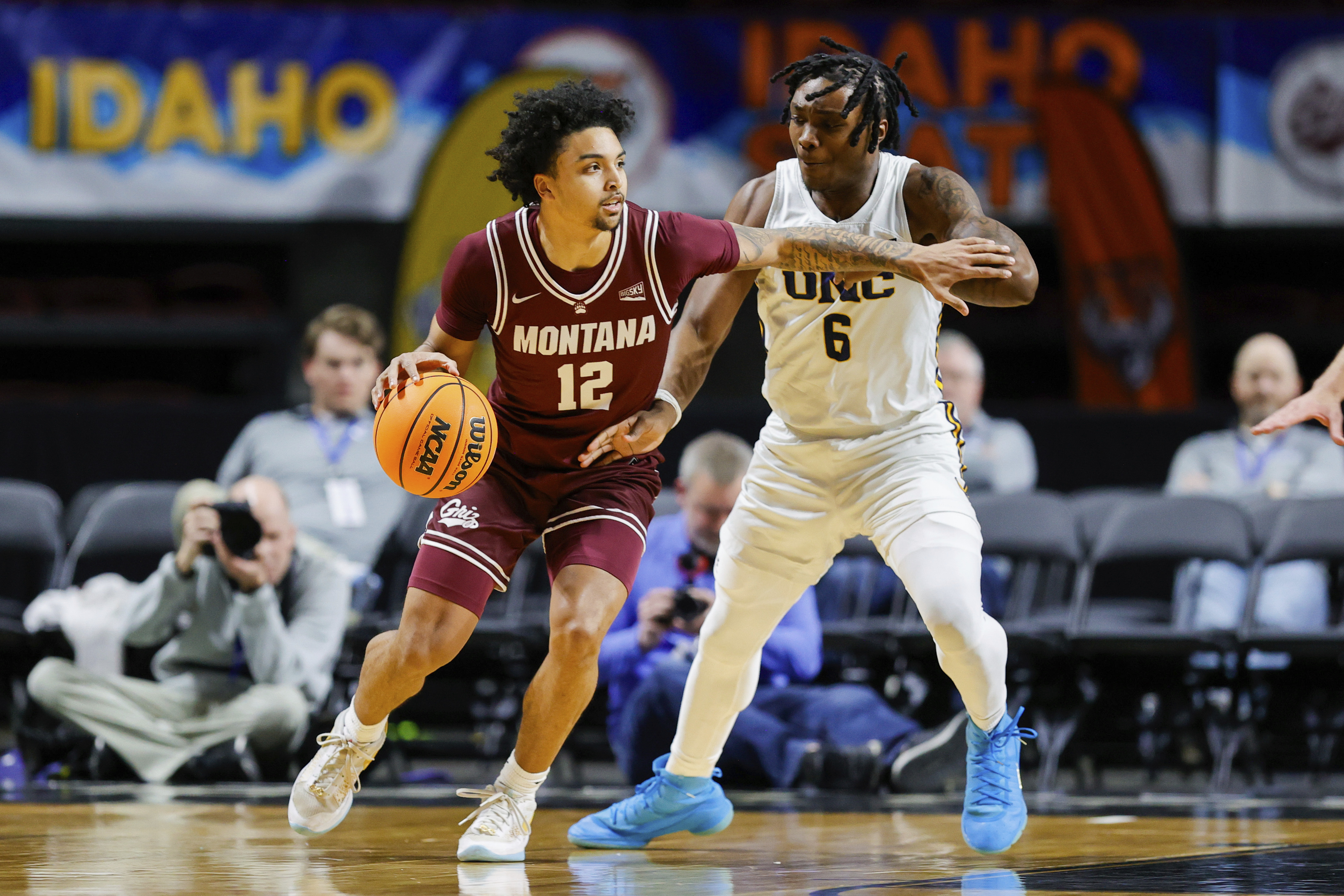Montana guard Brandon Whitney (12) works the ball around the defense of Northern Colorado guard Langston Reynolds (6) during an NCAA college basketball game in the championship of the Big Sky tournament, Wednesday, March 12, 2025, in Boise, Idaho. 
