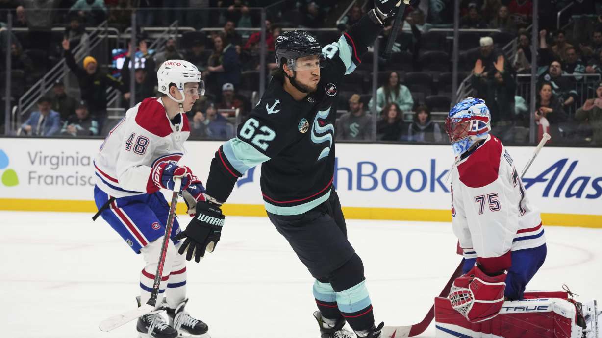 Seattle Kraken defenseman Brandon Montour (62) reacts to scoring to win 5-4 in overtime as Montreal Canadiens defenseman Lane Hutson (48) and goaltender Jakub Dobes (75) react in an NHL hockey game Wednesday, March 12, 2025, in Seattle.