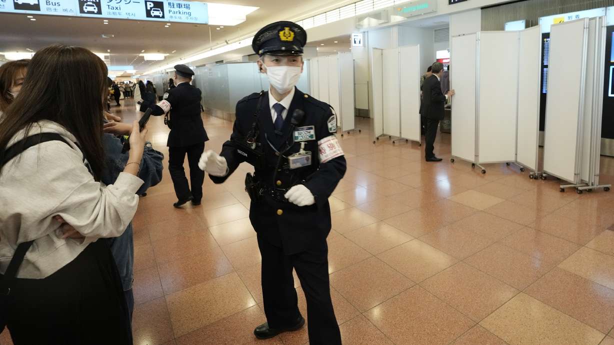 Fans of Los Angeles Dodgers wait for the team arrival as a staff installs partitions to block fans from the arrival route of the Dodgers team members at Tokyo International Airport Thursday, March 13, 2025, in Tokyo, as Dodgers to play their MLB opening games against and Chicago Cubs in Tokyo.