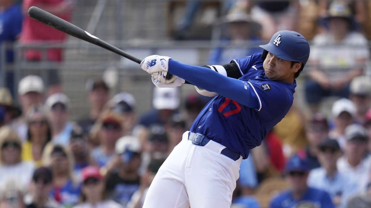 Los Angeles Dodgers designated hitter Shohei Ohtani, of Japan, follows through with his swing during the second inning of a spring training baseball game against the Cleveland Guardians, Tuesday, March 11, 2025, in Phoenix.