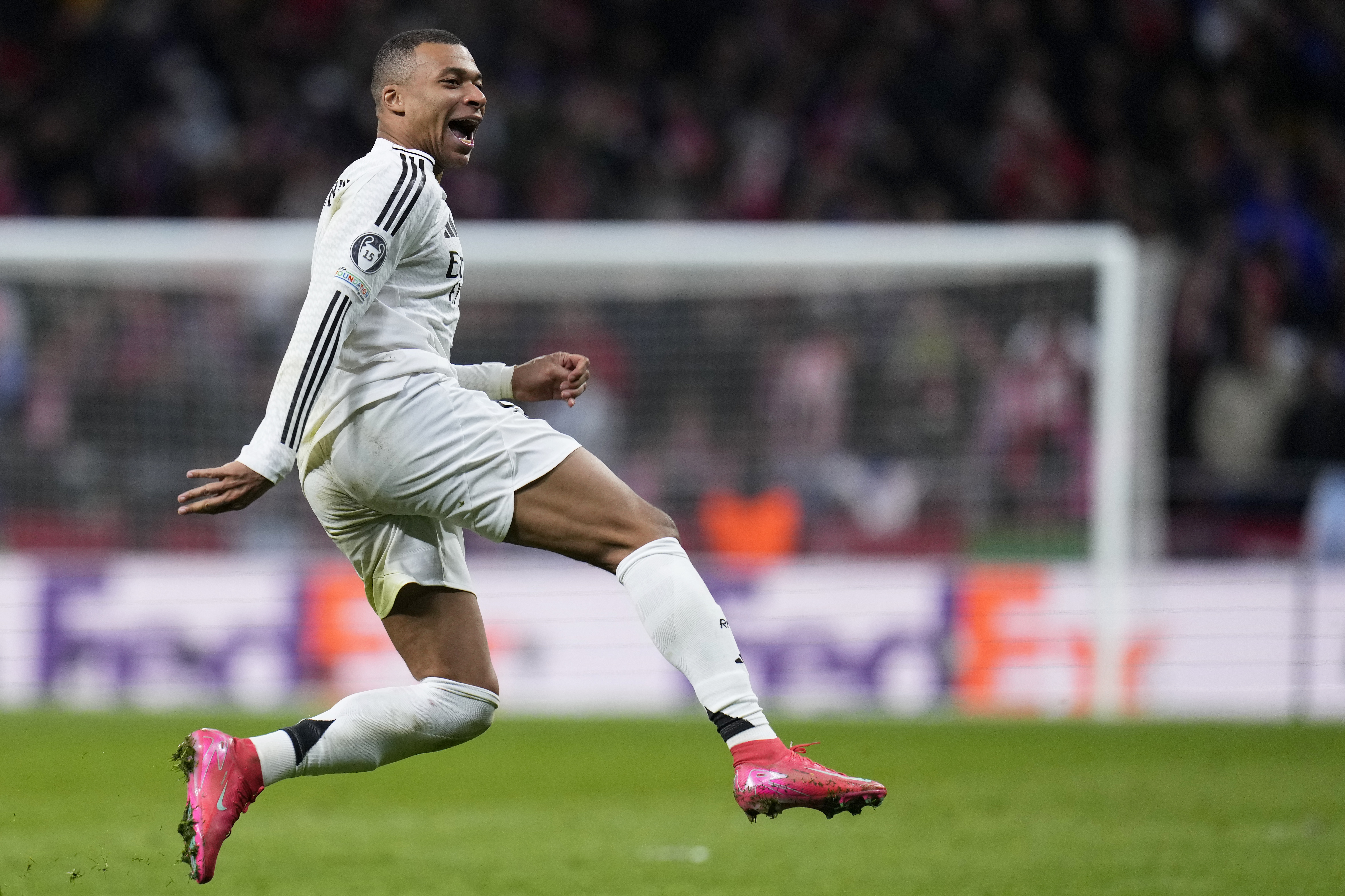 Real Madrid's Kylian Mbappe celebrates after a penalty shootout at the end of the Champions League round of 16, second leg, soccer match between Atletico Madrid and Real Madrid at the Metropolitano stadium in Madrid, Spain, Wednesday, March 12, 2025.