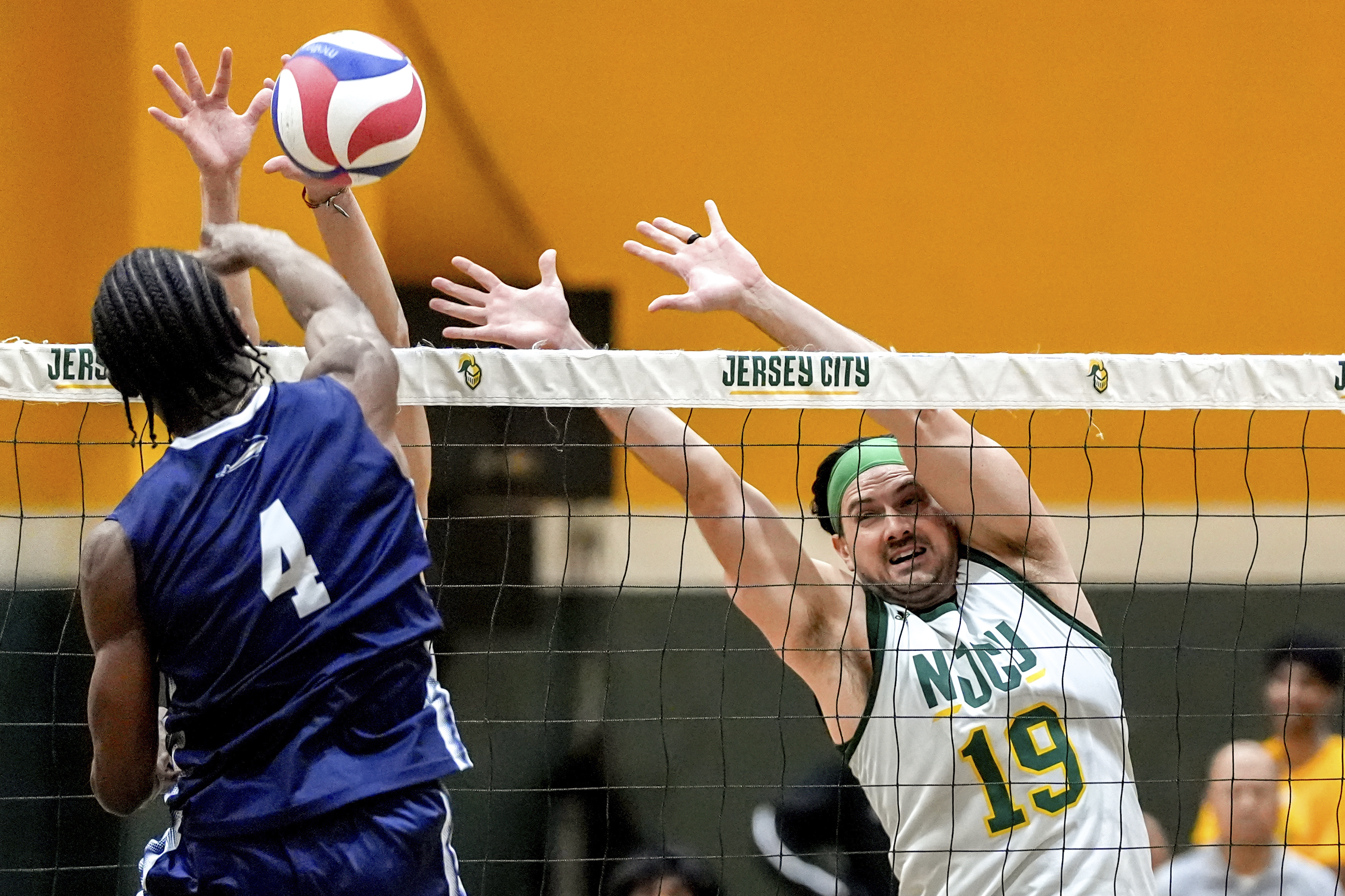 Damon LaSalle (19) blocks against University of Mount Saint Vincent's Olatomiwa Ibitayo (4) during a men's NCAA Division III college volleyball game, Wednesday, March 5, 2025, at New Jersey City University in Jersey City, N.J.