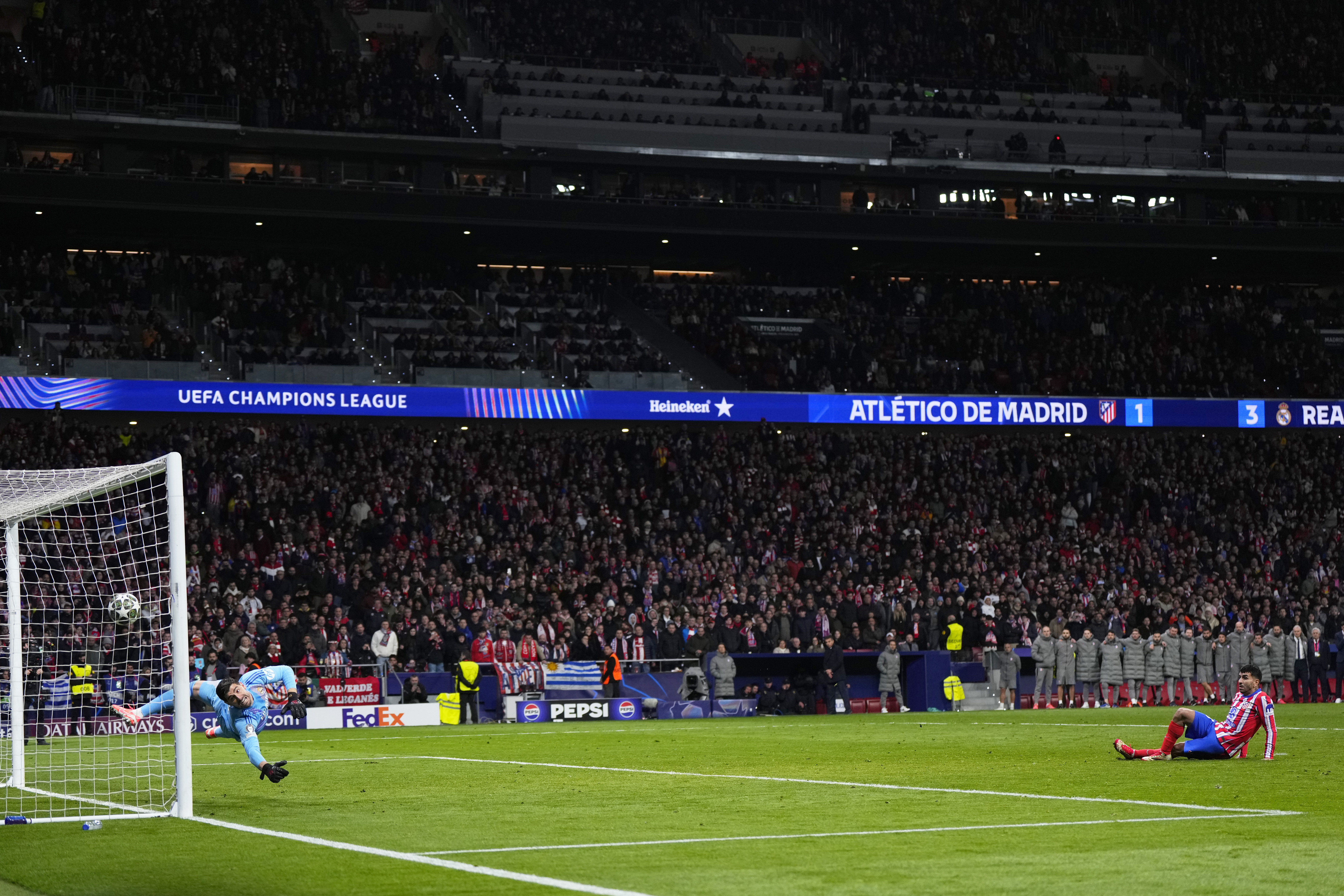 Atletico Madrid's Julian Alvarez falls to the ground after taking a penalty kick during a shootout at the end of the Champions League round of 16, second leg, soccer match between Atletico Madrid and Real Madrid at the Metropolitano stadium in Madrid, Spain, Wednesday, March 12, 2025.