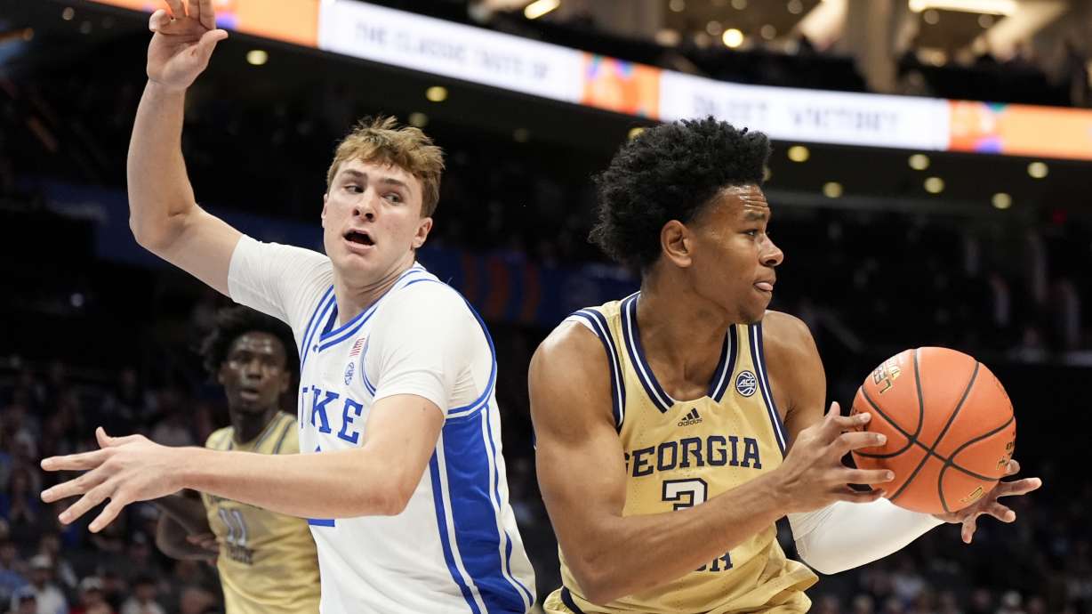 Georgia Tech guard Jaeden Mustaf drives to the basket past Duke forward Cooper Flagg during the first half of an college basketball game in the quarterfinals of the Atlantic Coast Conference tournament, Thursday, March 13, 2025, in Charlotte, N.C.