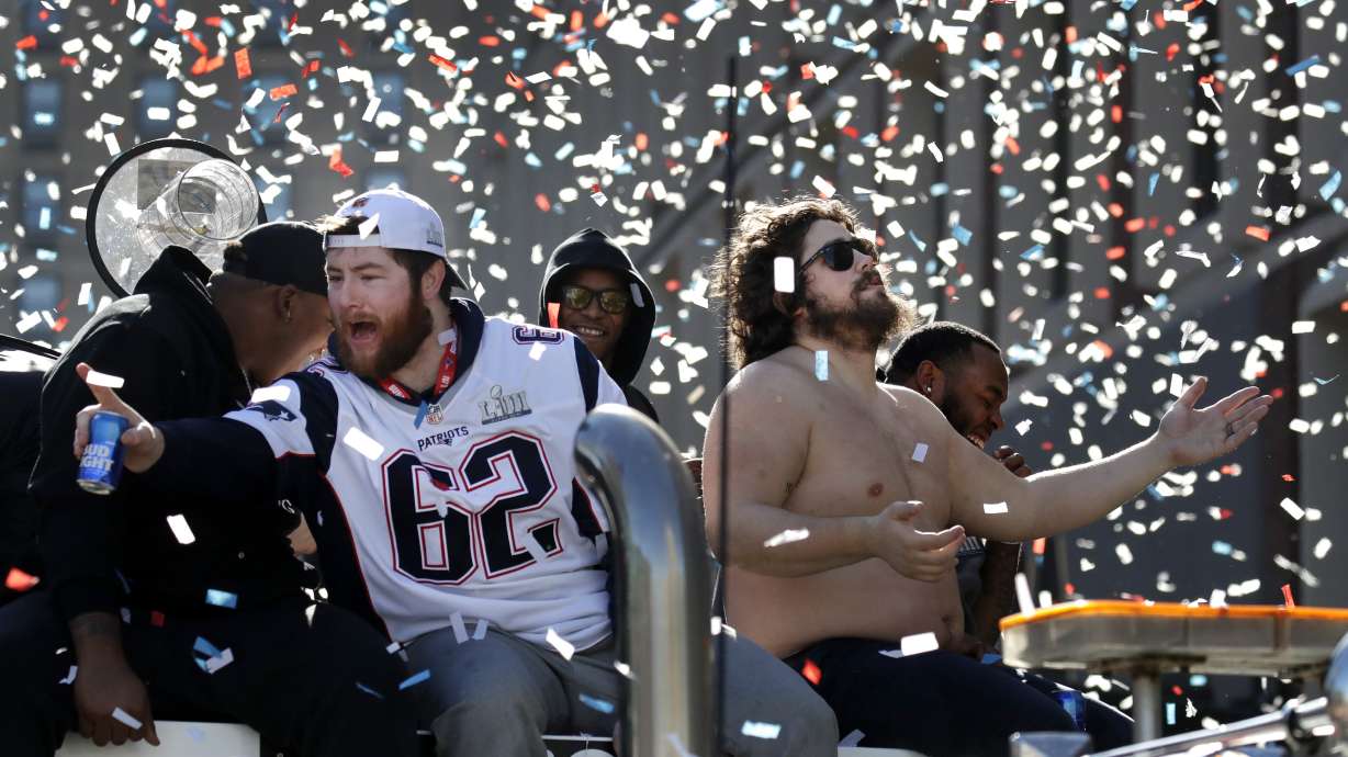 FILE - New England Patriots' Joe Thuney (62) and David Andrews react to fans during a victory parade in downtown Boston, Tuesday, Feb. 5, 2019, to celebrate their win over the Los Angeles Rams in Sunday's NFL Super Bowl 53 football game in Atlanta. The Patriots have won six Super Bowl championships.