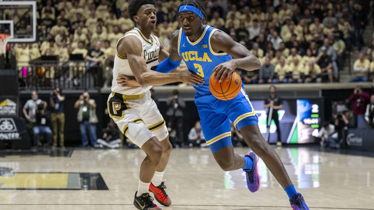 Purdue guard Myles Colvin, left, defends against UCLA guard Eric Dailey Jr. (3) during the first half of an NCAA college basketball game, Friday, Feb. 28, 2025, in West Lafayette, Ind.