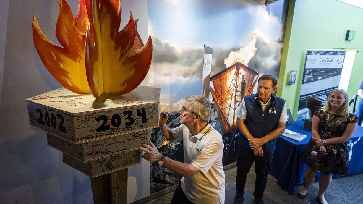International Olympic Committee President Thomas Bach signs the 2034 torch display in Park City on Sept. 28. 2024. The IOC has signed a $3 billion deal for broadcasting rights, including the 2036 Games in Salt Lake City.